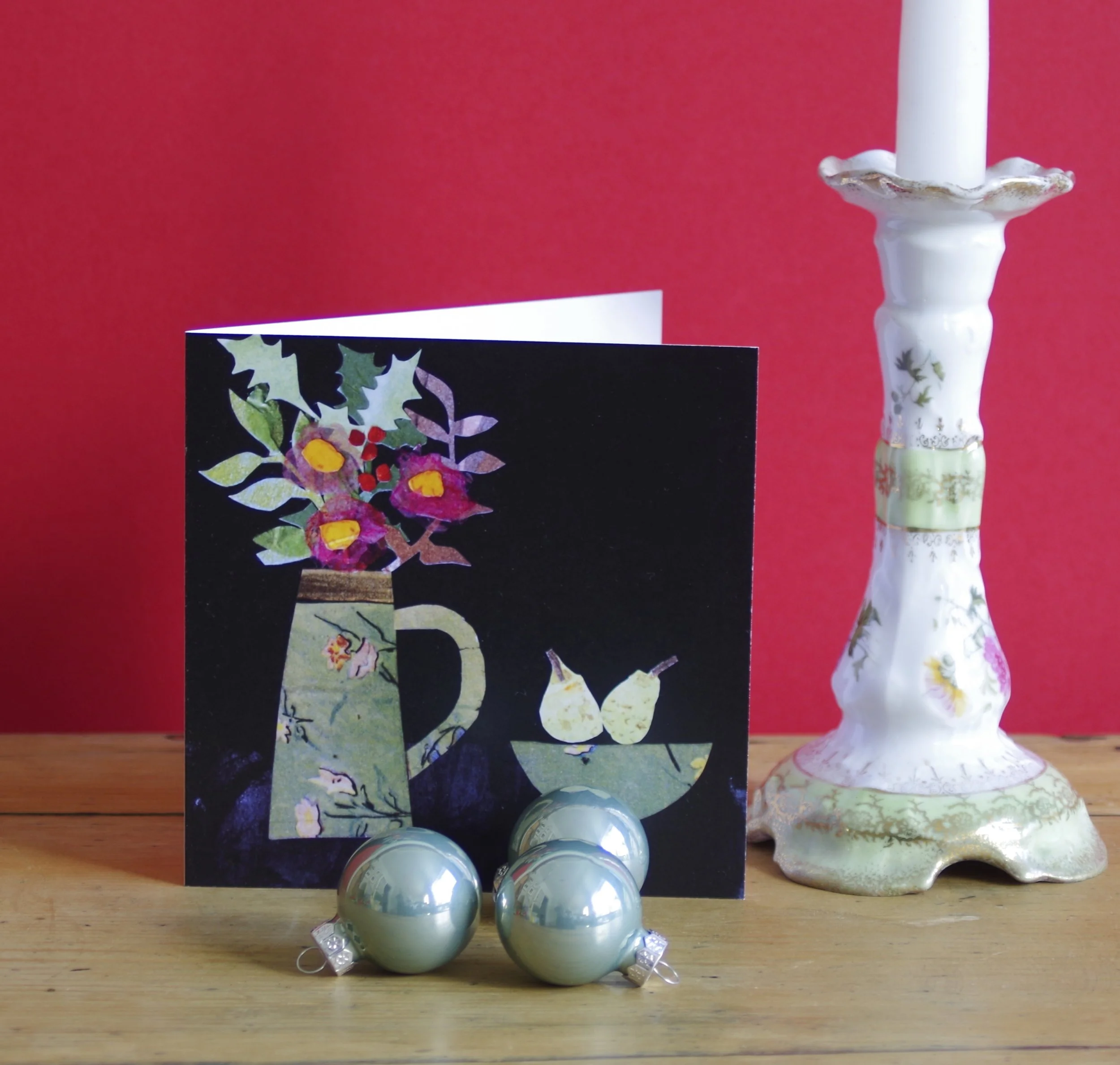 This is a collaged greeting card with and bowl of pears, and which celebrates the seasonal flowers and foliage found during winter time.
