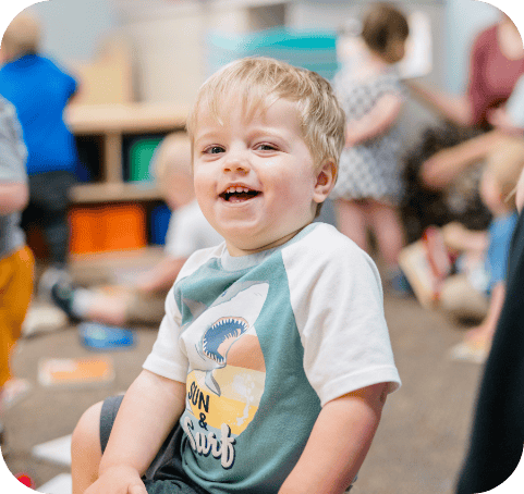 Monkey room kid daycare smiling with kids in the background