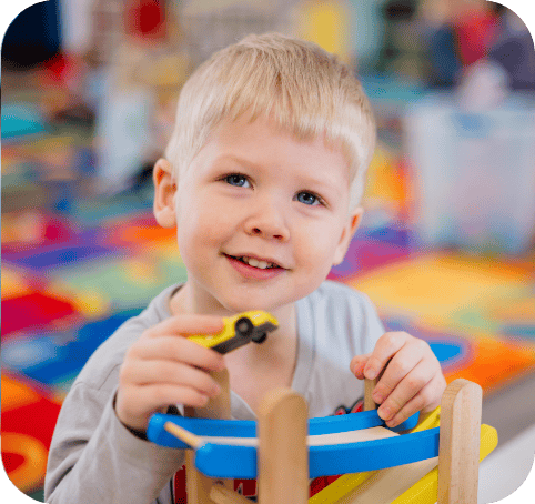 Kangaroo kid daycare smiling playing with cars