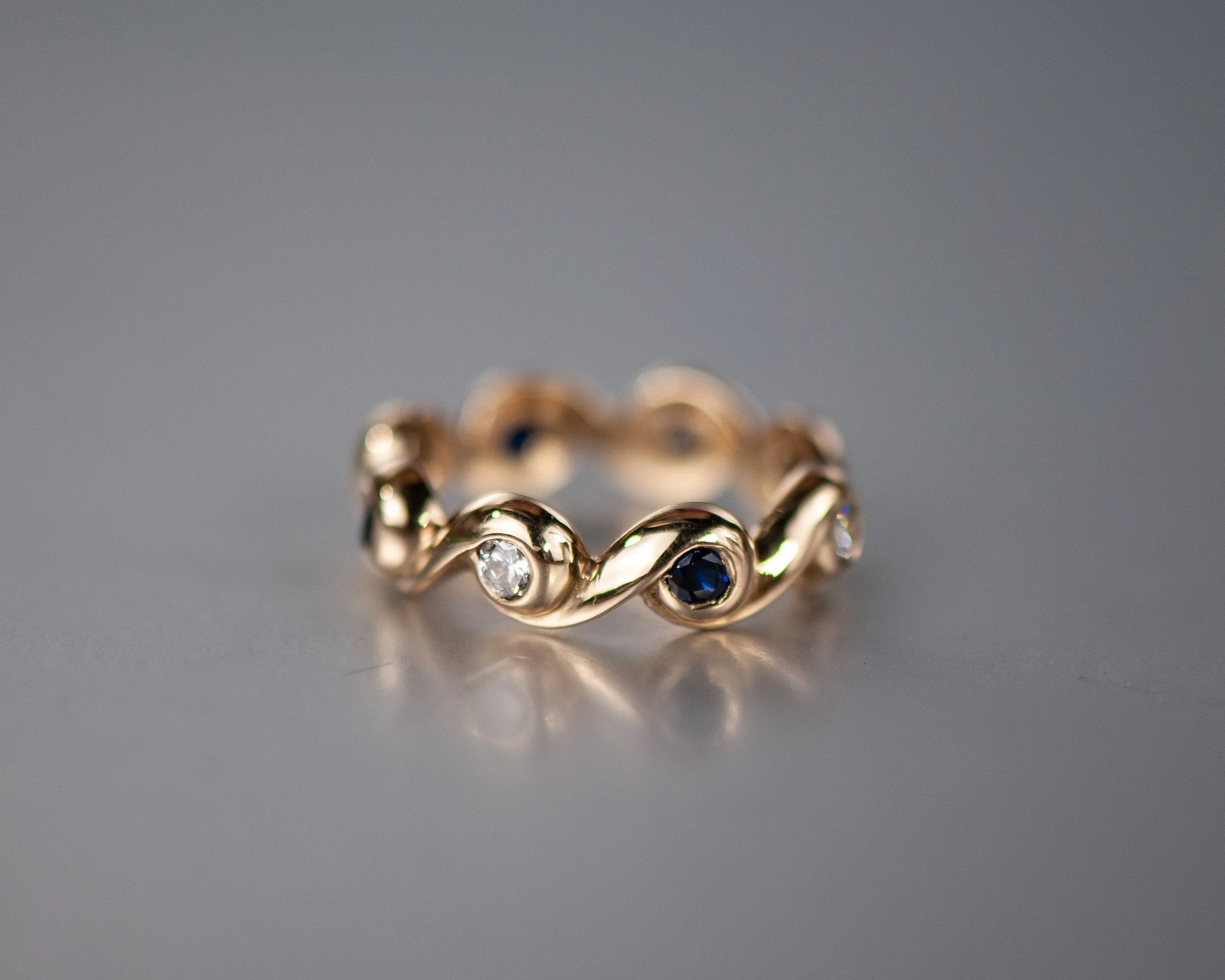 Custom wave design, hand carved carved, lab diamonds and lab blue sapphires