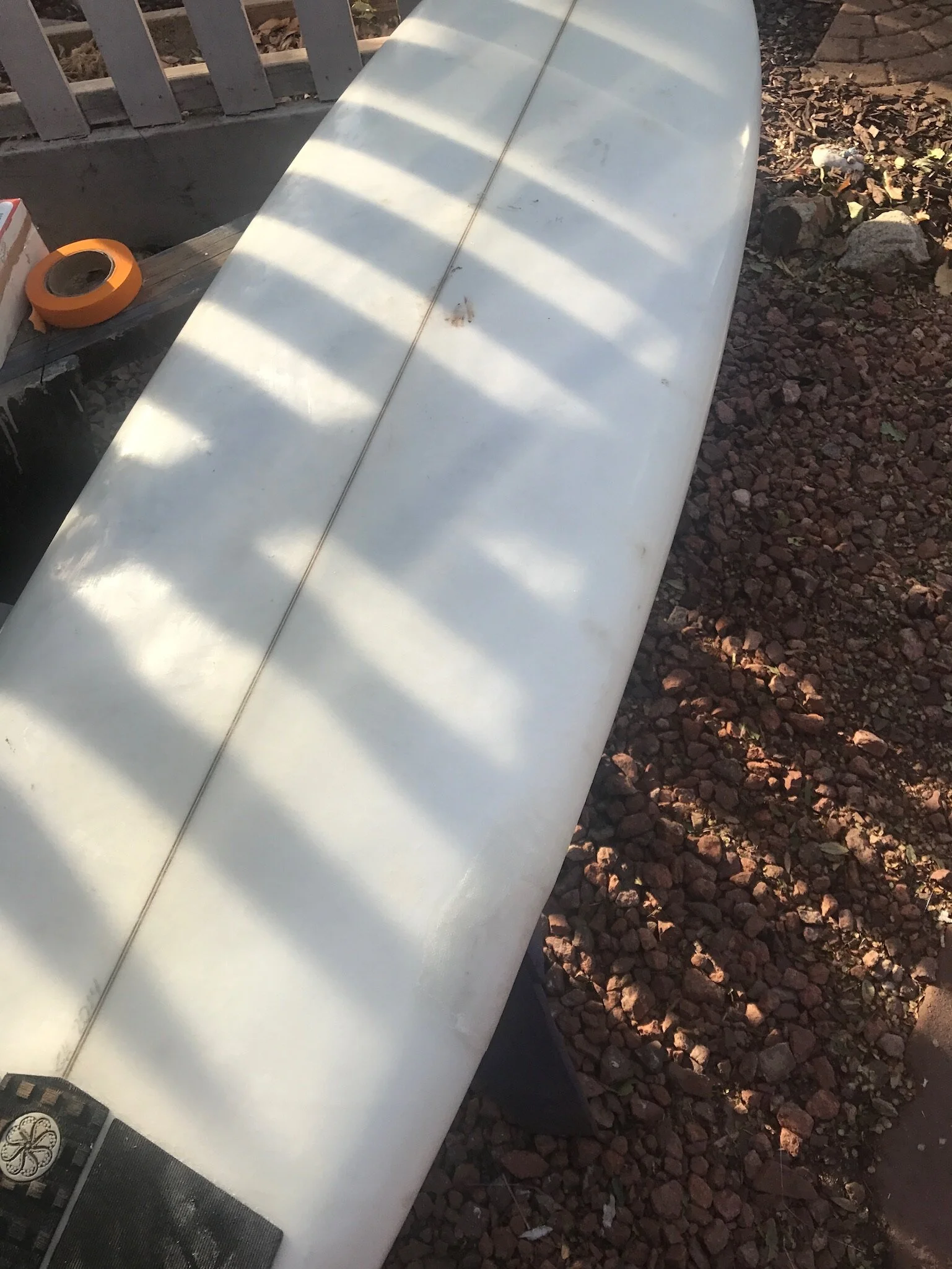 Epoxy is sanded and fiberglass sheets are laid down with another coating of resin.  