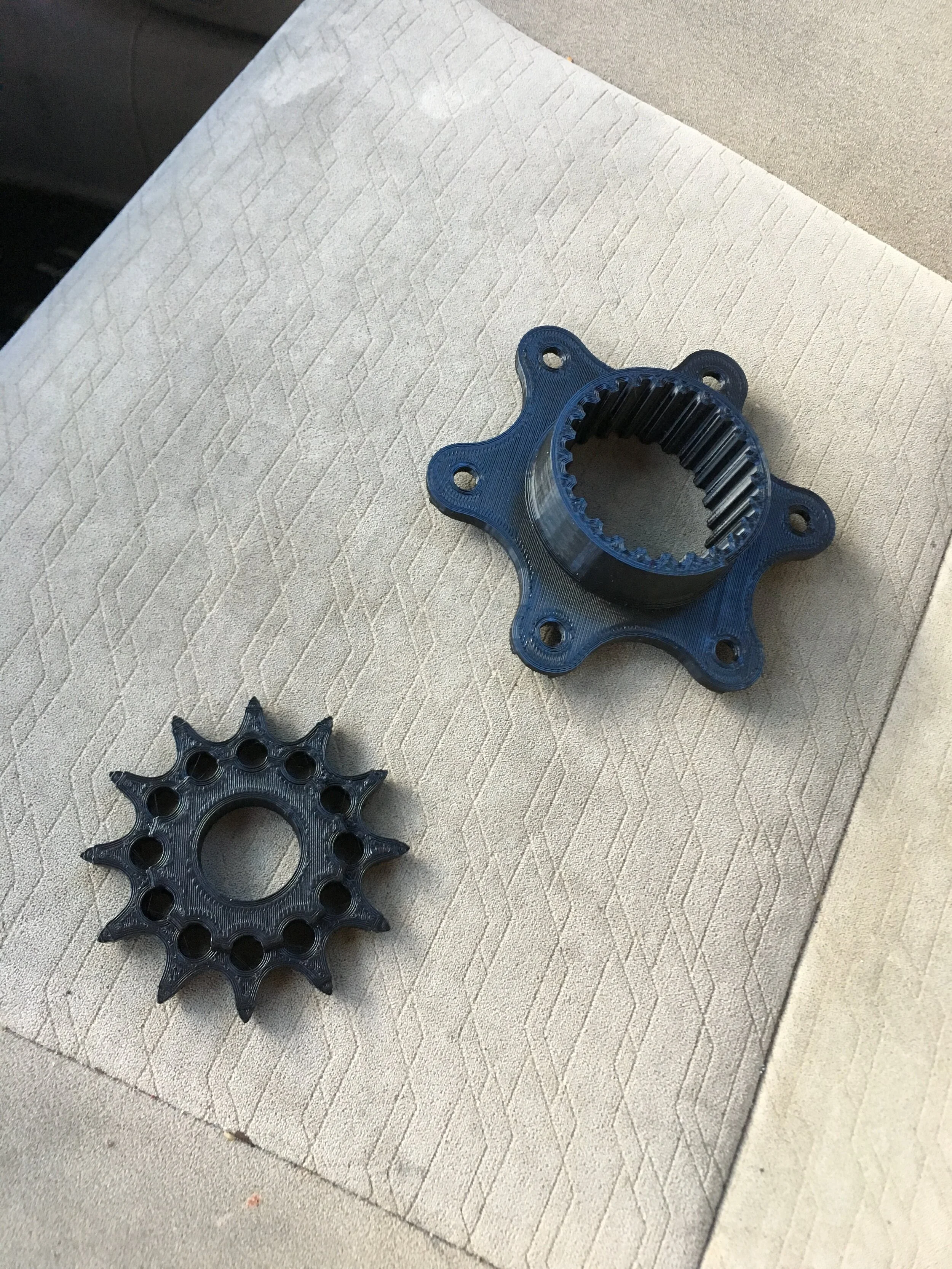 Printing parts helped confirm CAD design approaches. In this case, printing the Front Sprocket and a Power Adapter to test the spline design on an Off-the-Shelf differential, confirms the math used behind the splines before buying the material. 