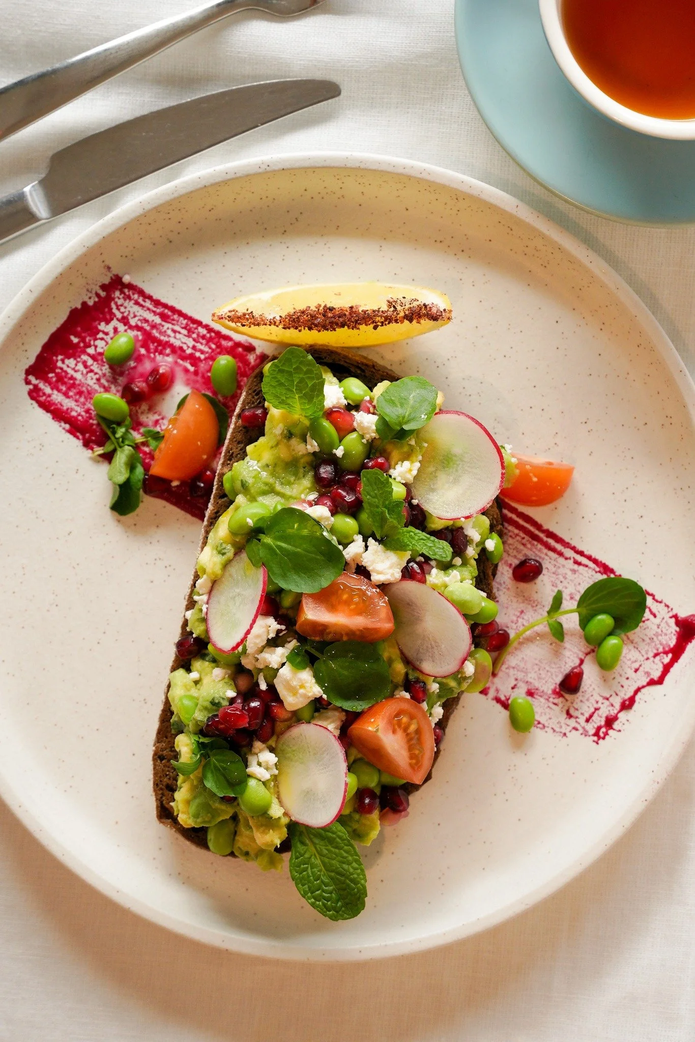 Bring a little colour to your plate with our fan-favourite Smashed Avo 🥑🍅

Creamy avo on rye toast, with topped edamame, feta and cherry tomatoes. Paired with zingy pomegranate seeds and fresh beetroot pur&eacute;e, it&rsquo;s the veggie-packed bre