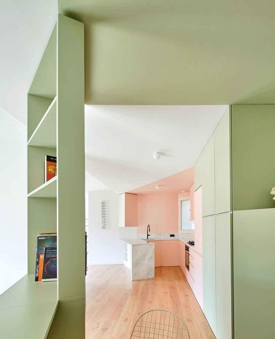 Using colour and joinery to define space|⁠
⁠
Custom made pastel green joinery volumes create a labyrinth of quirky rooms within rooms. ⁠
⁠
Open shelving, seating nooks, sleeping platforms, and desk spaces frame the interior spaces before morphing int