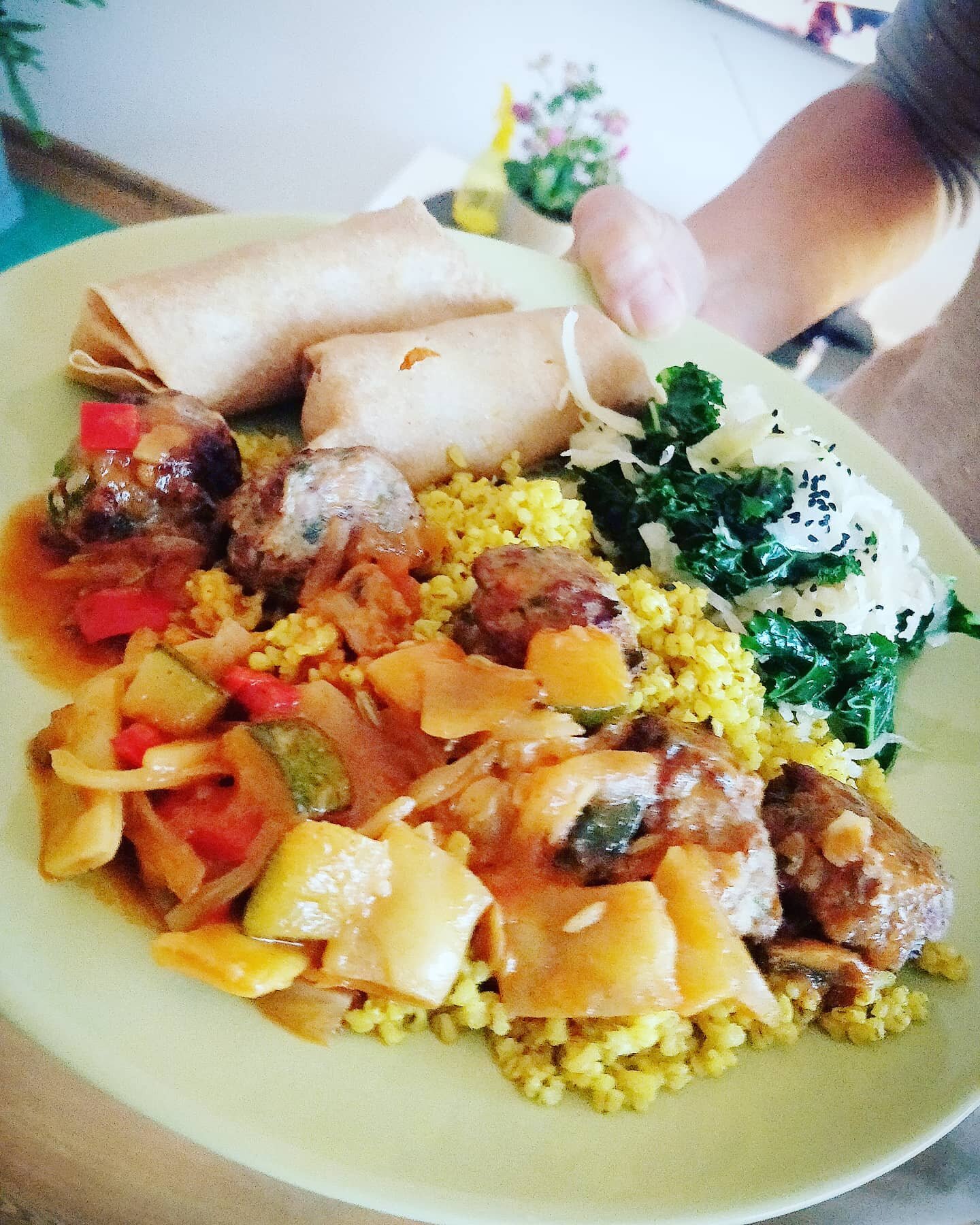 An autumnal dinner on this wet and cold day...🍁🍂

Spicy pumpkin spring rolls ( wraps made with spelt flour) barley-couscous (with turmeric, salt, olive oil) steamed kale, w homemade sauerkraut w milk thistle oil) 
goulash with tempeh/cranberry ball