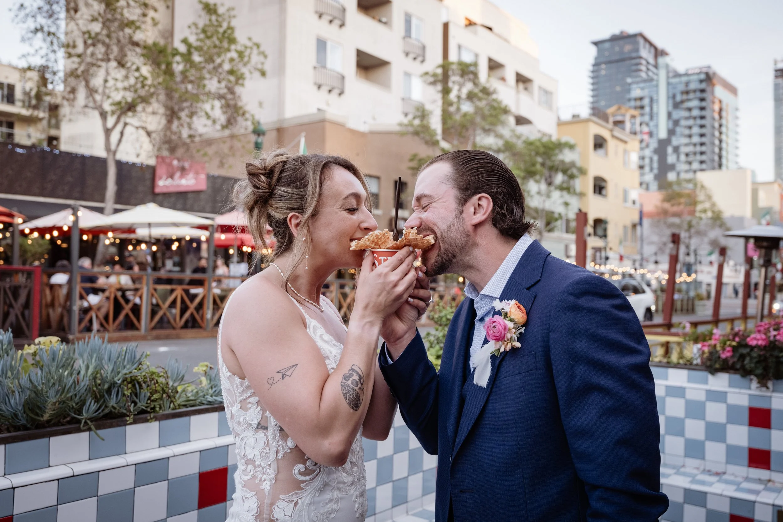 Elopement couple eating ice cream in Little Italy, San Diego — candid wedding day moments