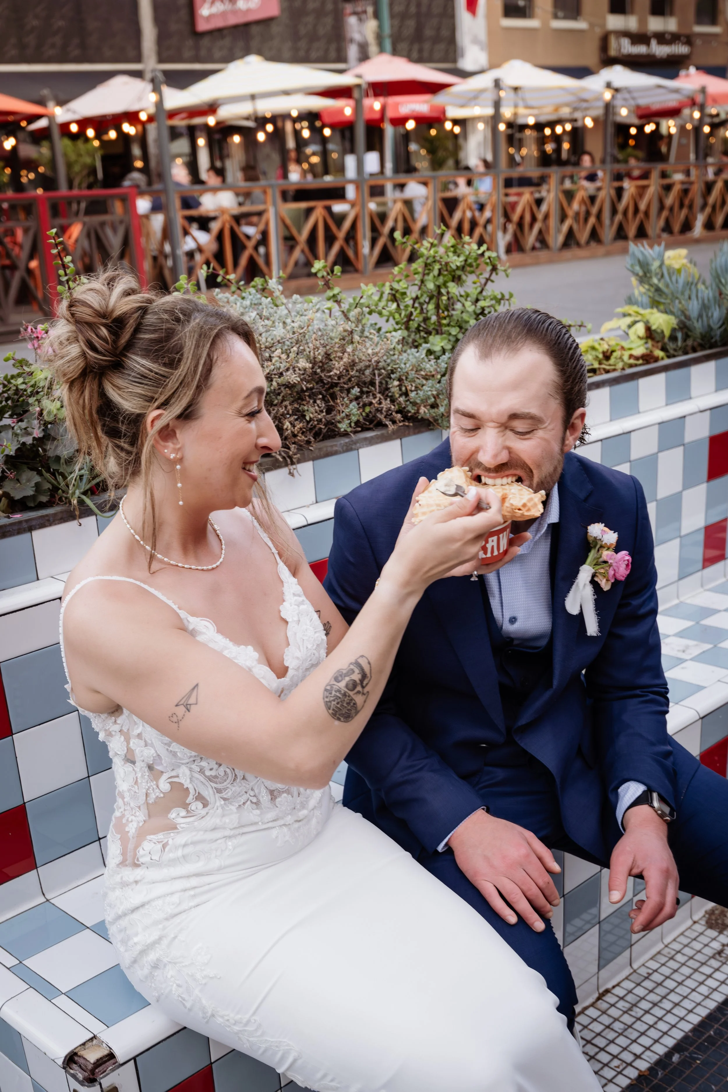 Candid elopement portraits — couple sharing ice cream in Little Italy San Diego