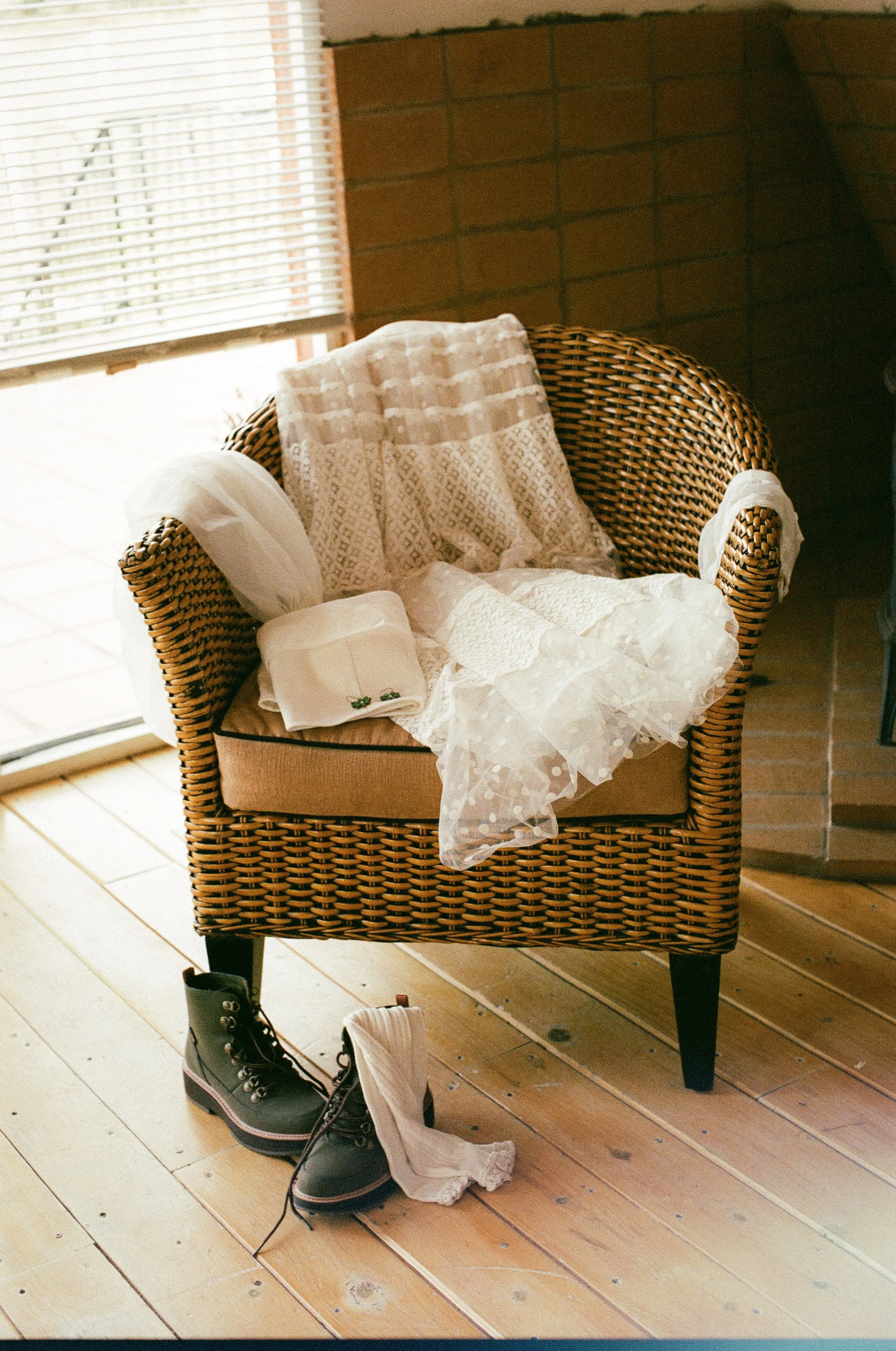 Brides Dress and hanging over a chair captured on 35mm film