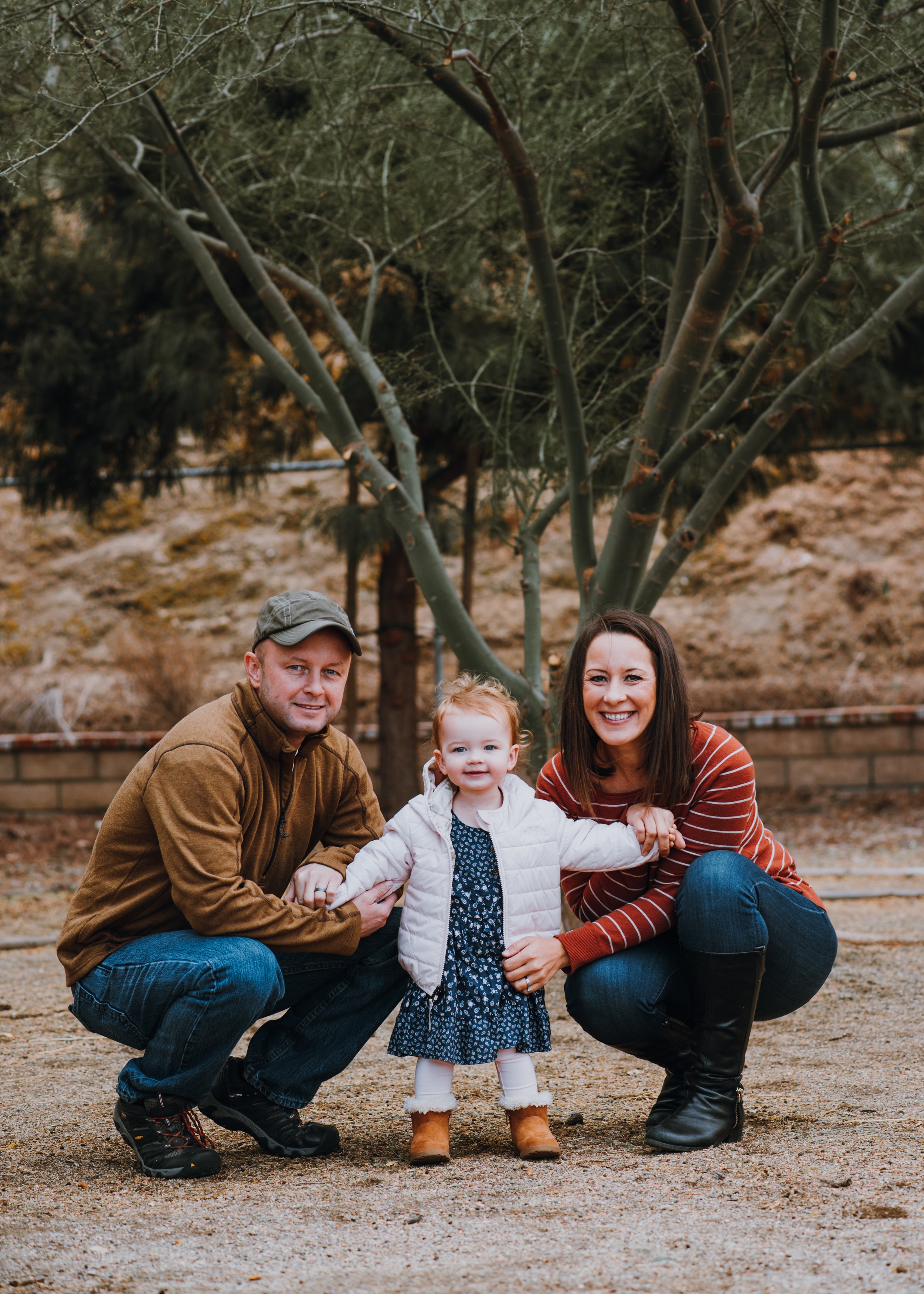 Family of three- parents with their toddler daughter