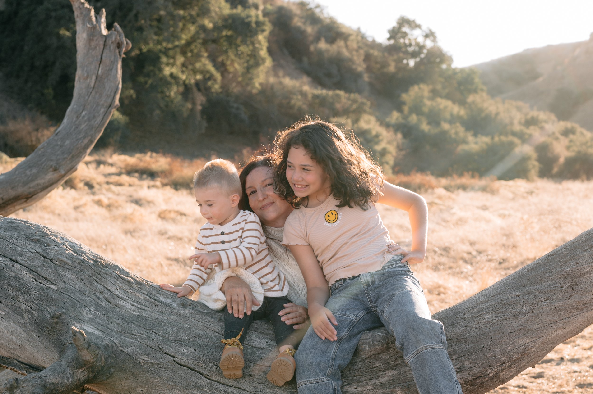 grandmother with her grandchildren playing around and snuggling up