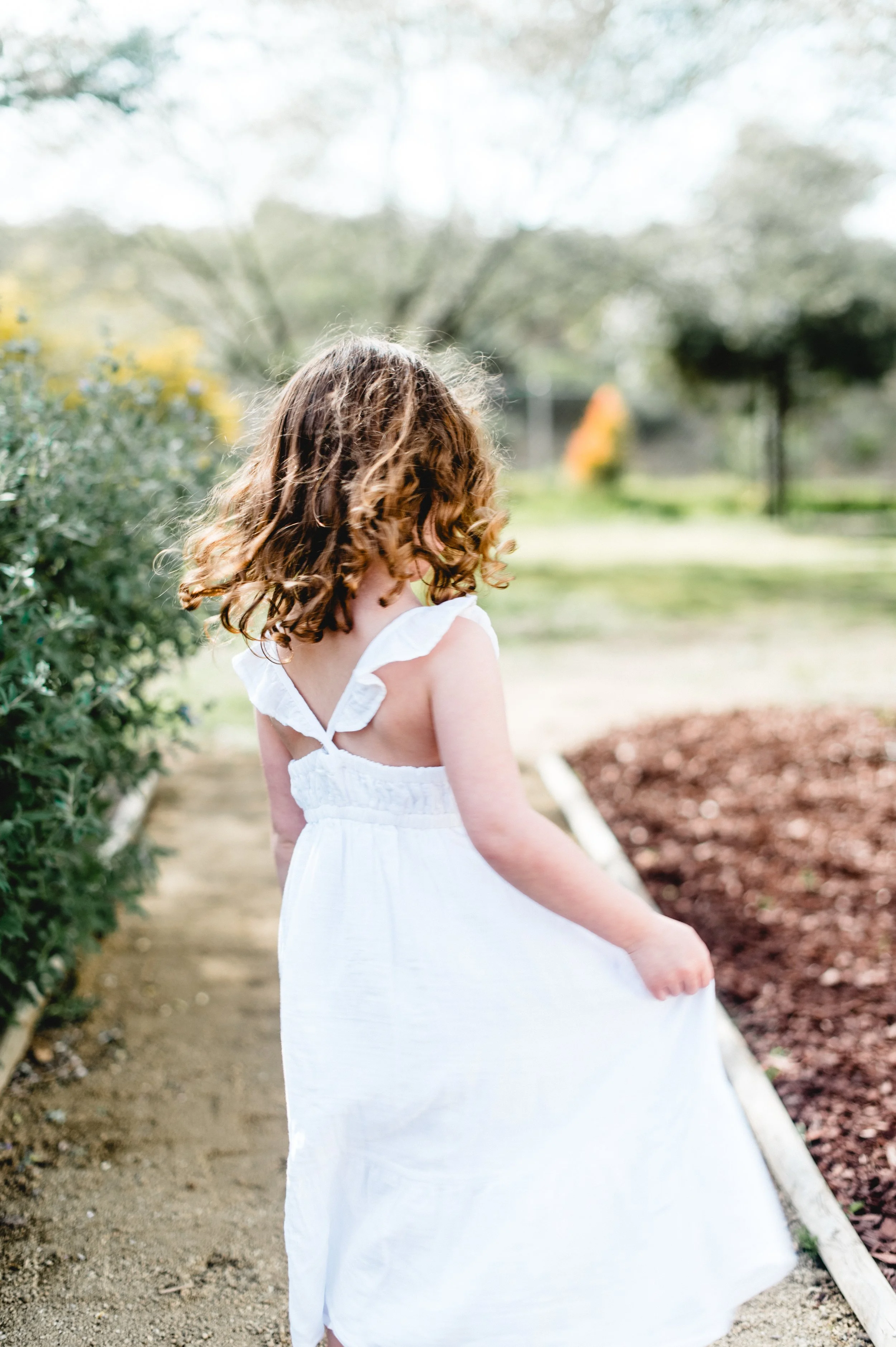 little girl twirling in her white dress