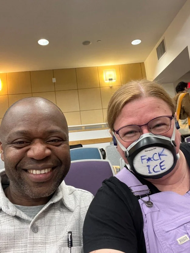 Crystal and will sitting together in an auditorium.