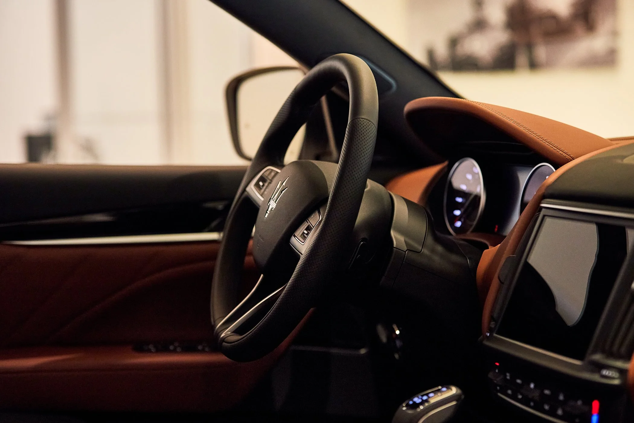 Maserati steering weel and finest leather from the inside shows the amazing interior in brilliance in the car dealership brand new of the year taken by commercial professional photographer torsten glaenzel