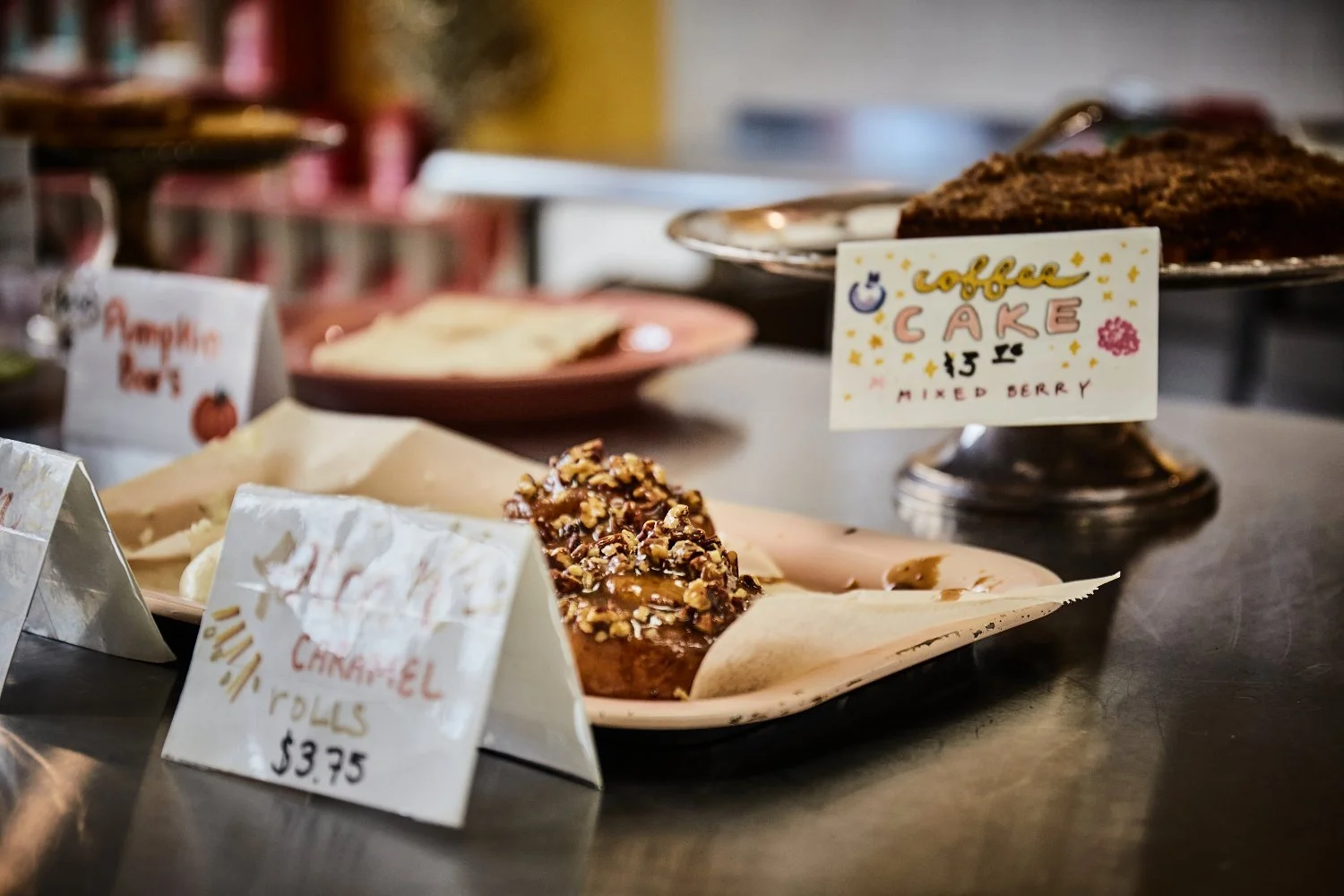 delicious caramel rolls with hot coffee tasting so amazing on the go or for takeout of the shop in downtown by torsten glaenzel commercial photography in Minnesota where the world becomes one place of harmony