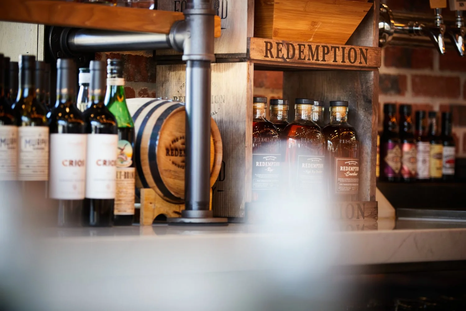 the bar and wine barrel are inviting to the next round in a chilling and warm atmosphere at the restaurant and cocktail bar by torsten glaenzel photography and the food
