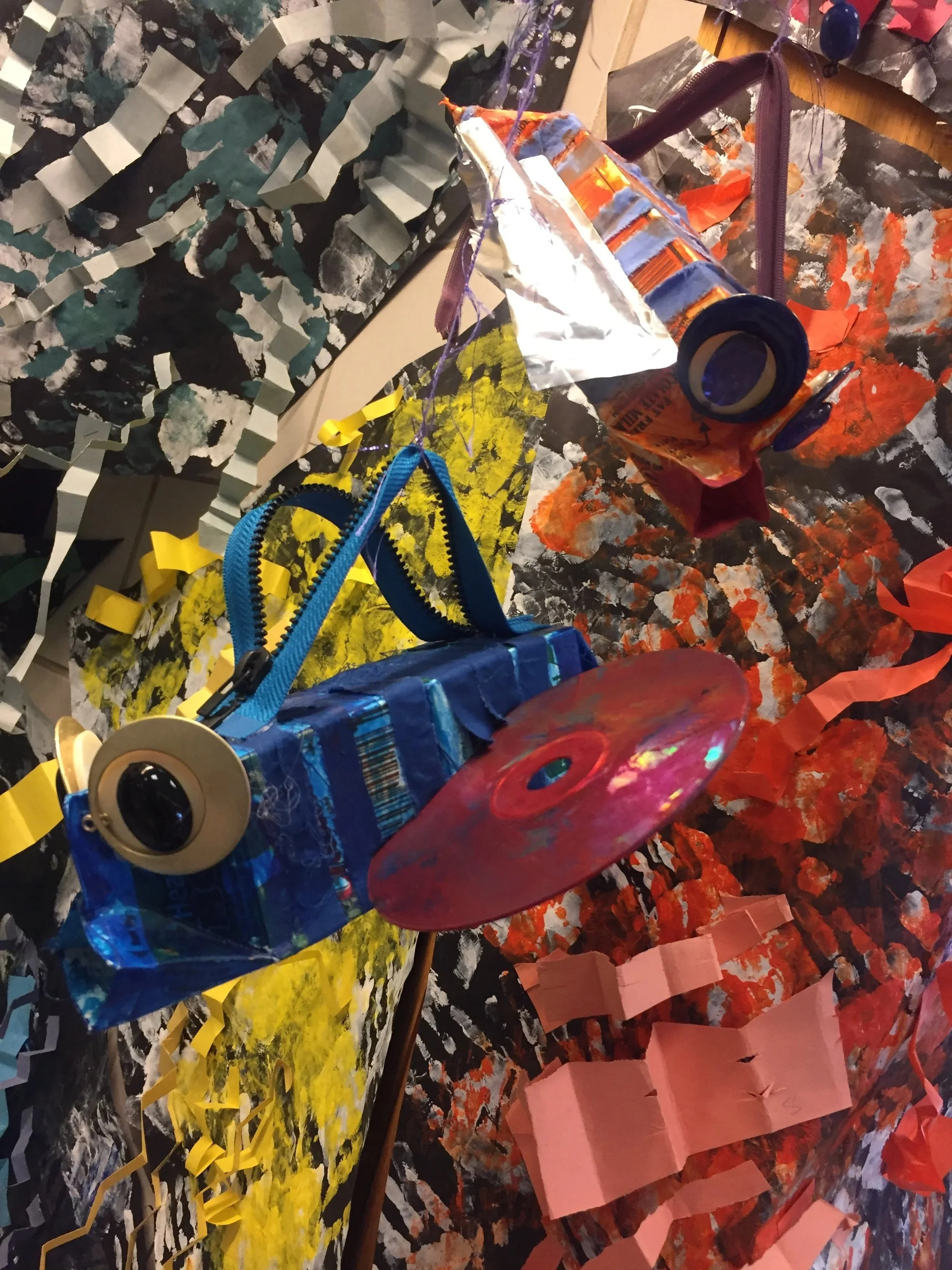 Fish made with milk cartons, zippers, buttons, CDs and Capri Sun containers