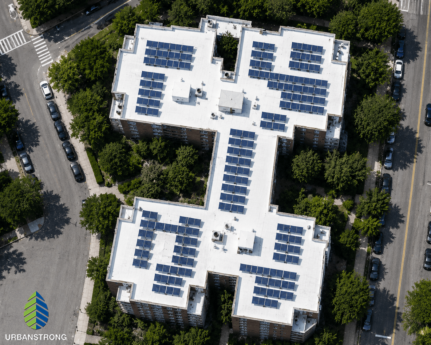 Satellite-style aerial image of an Urbanstrong rooftop solar project on a Bronx NYC co-op building with a white reflective roof and solar panel array.