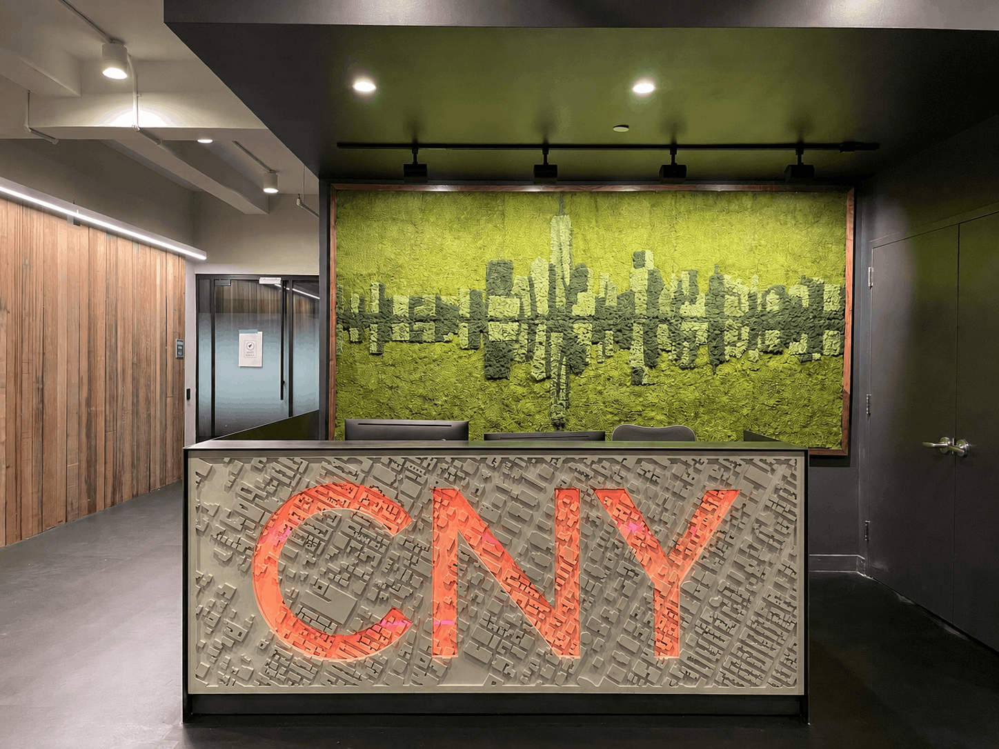 Custom NYC skyline moss mural above reception desk, CNY Construction office, Manhattan by Urbanstrong