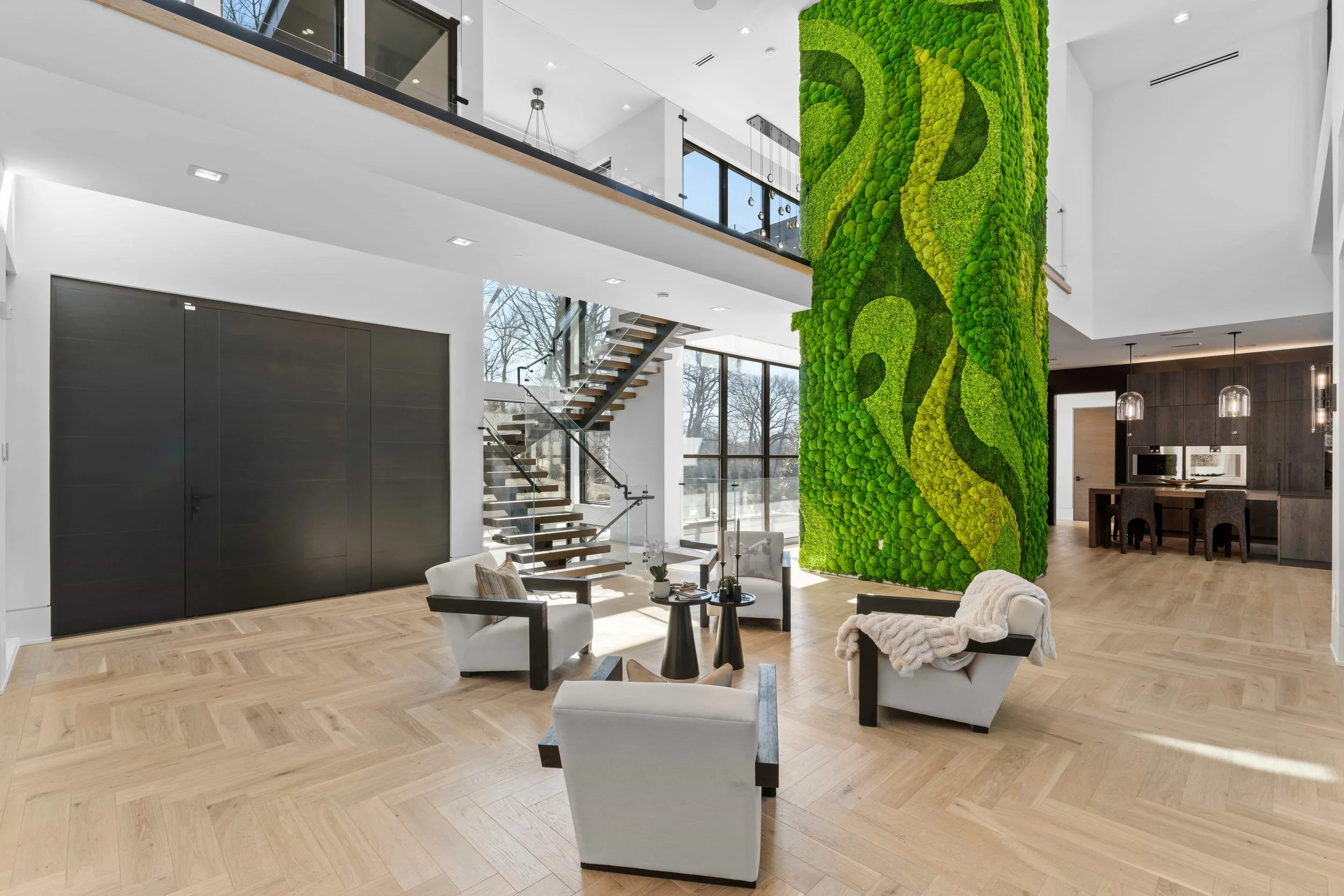 Preserved moss wall wrapping a double-height column in a luxury private residence, Englewood, NJ by Urbanstrong