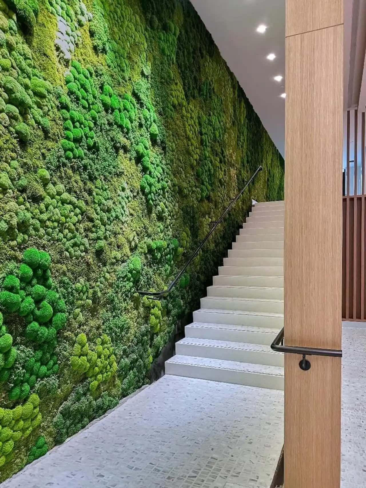 Preserved moss wall installation lining staircase in multifamily residential lobby, Bronx, NYC by Urbanstrong