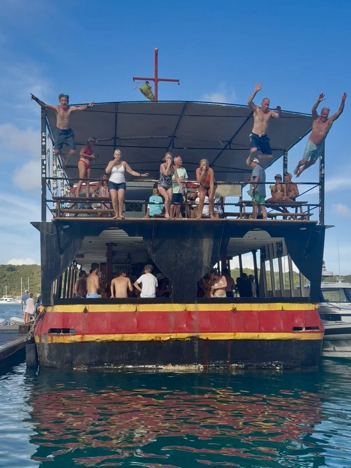 Guest jumping of Willie T in Normand Island, British Virgin Islands