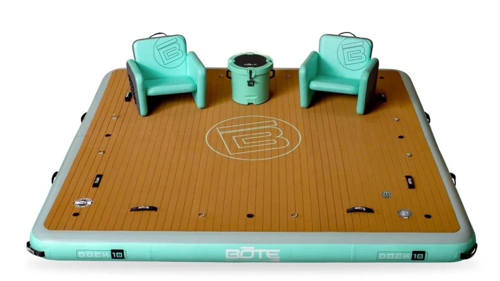 Floating dock with two turquoise chairs and a cooler in the middle.