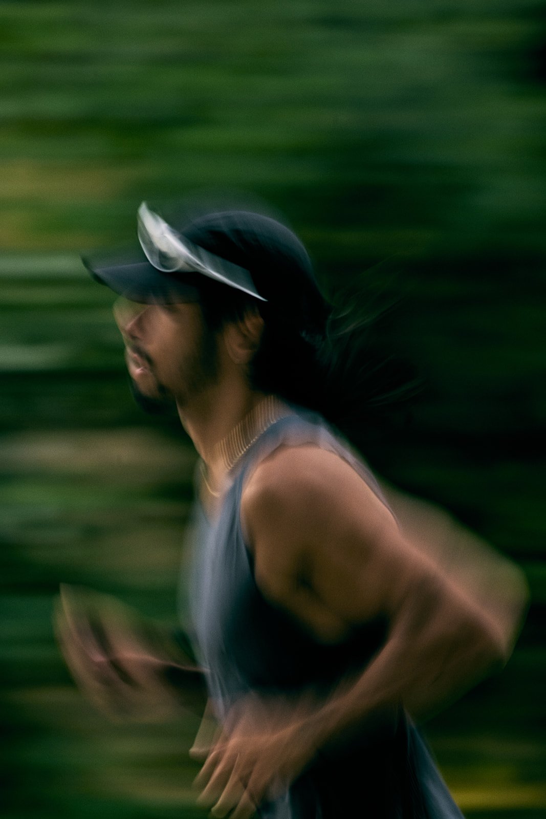 A person jogging outdoors with a blurred background.