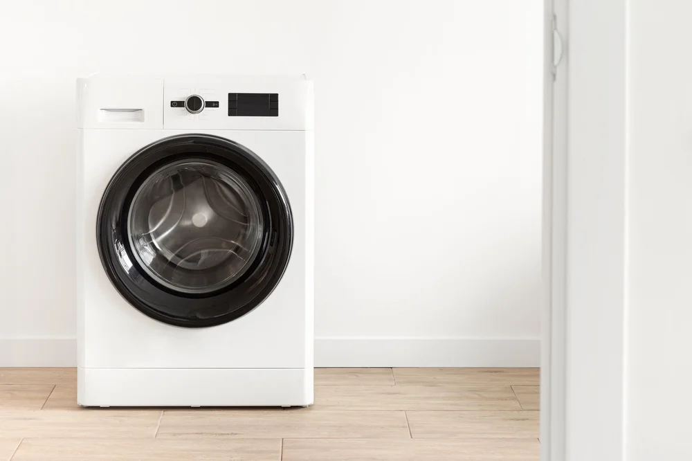 White washing machine in a bright laundry room