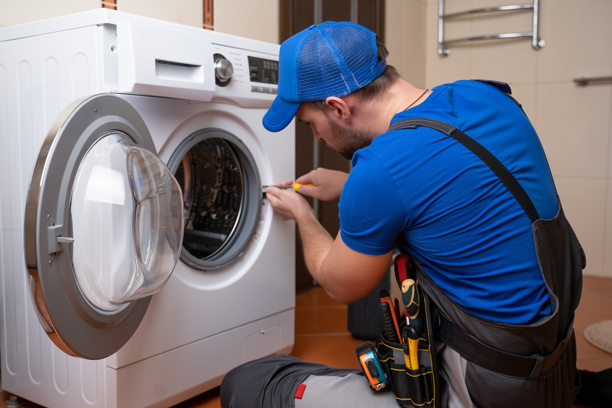 working-man-plumber-repairs-washing-machine-home-washing-machine-installation-repair-plumber-connecting-appliance.jpg