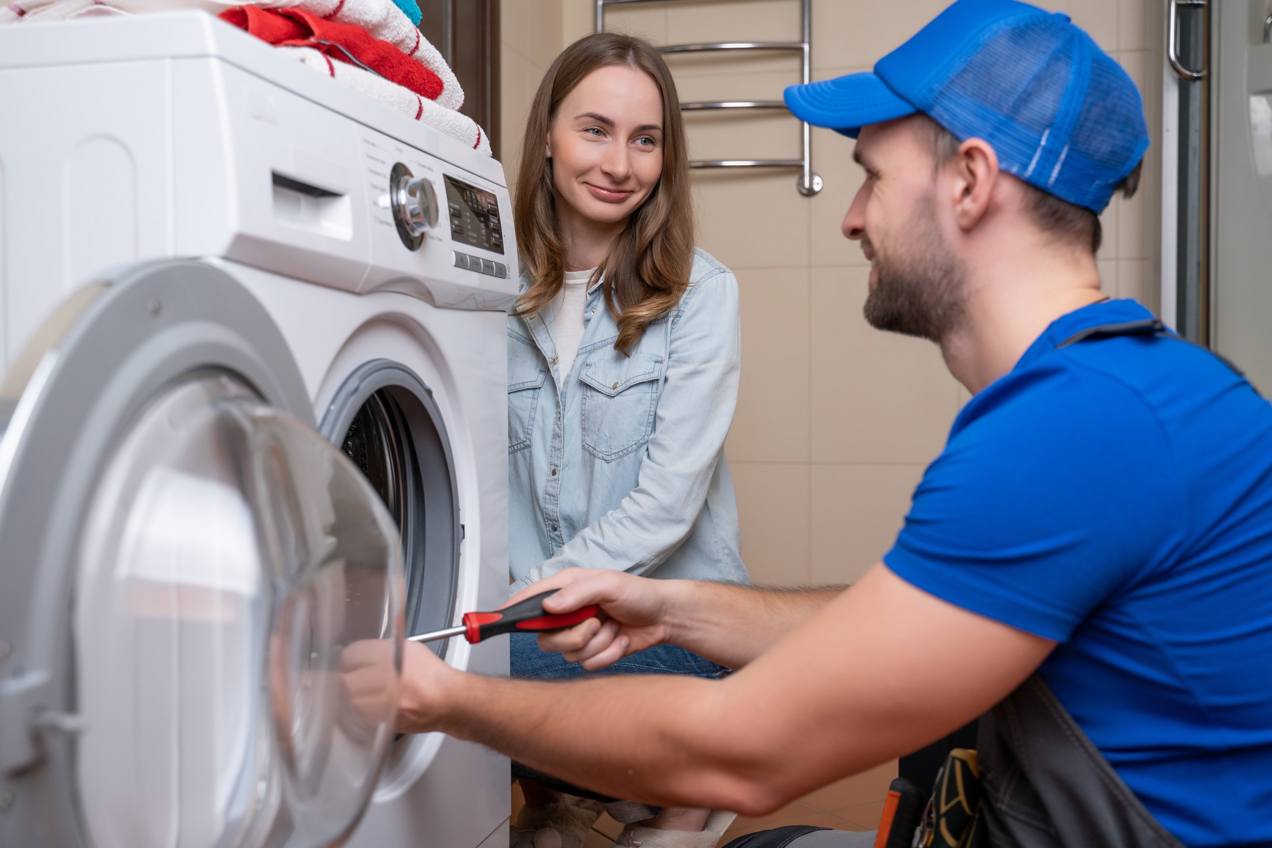 repairman-repairs-washing-machine-front-woman-man-communicates-with-owner-washing-machine.jpg