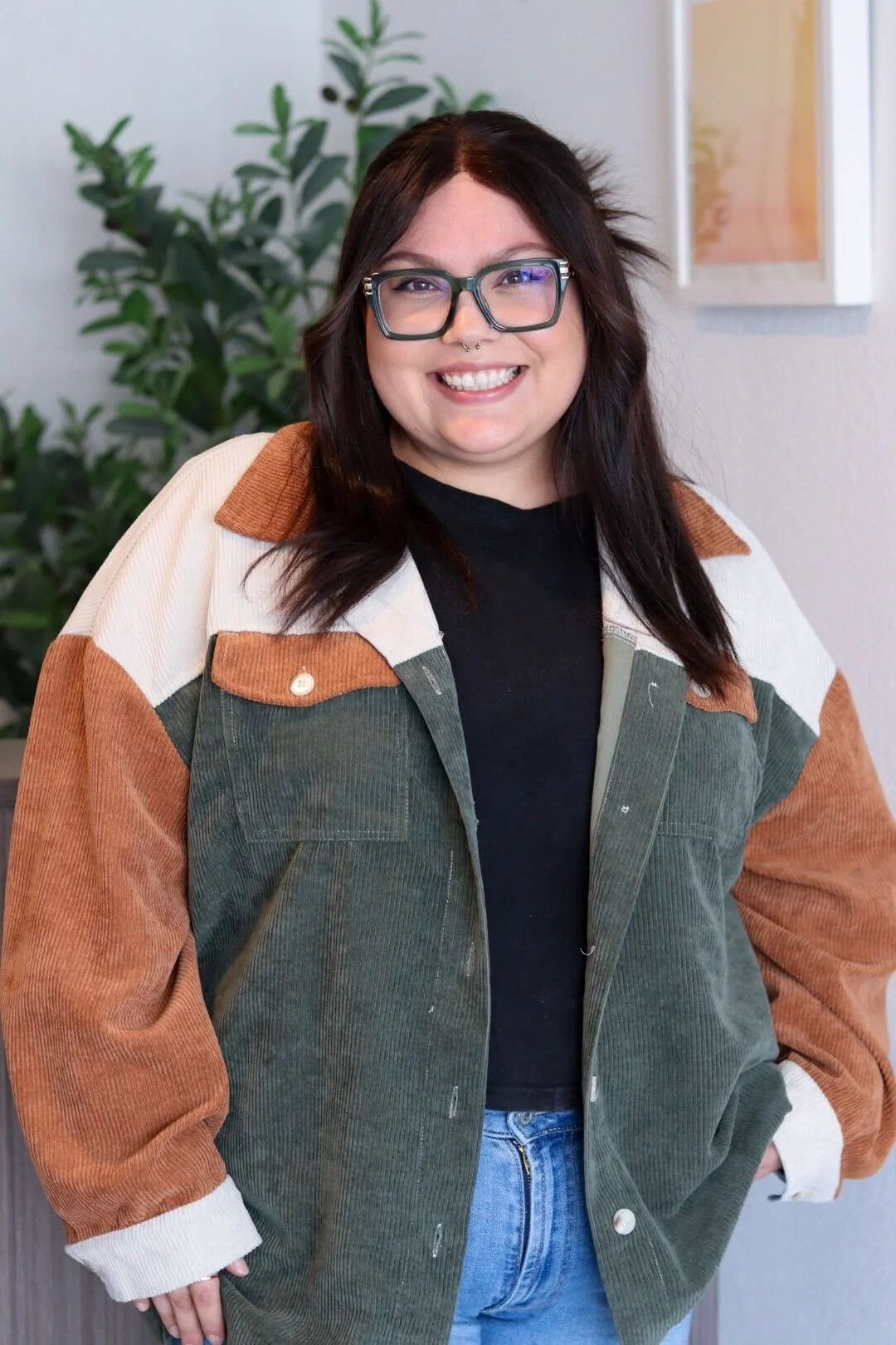 Allica Cardona, Therapist-In-Training in orange, grey, and white jacket