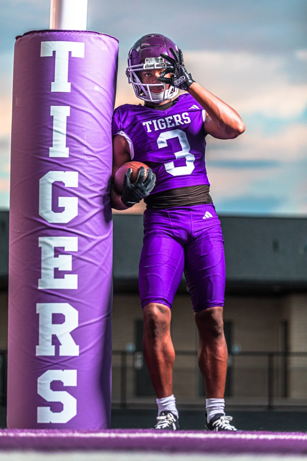 Football senior photo in purple Tigers uniform