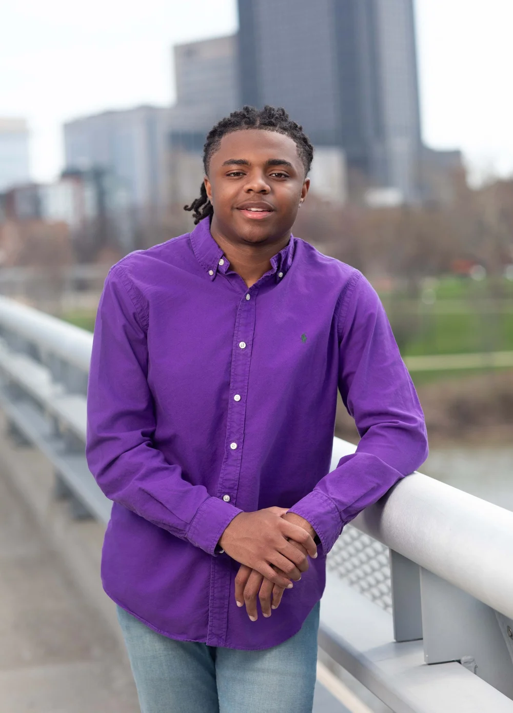 Senior portrait on a bridge with the Columbus skyline