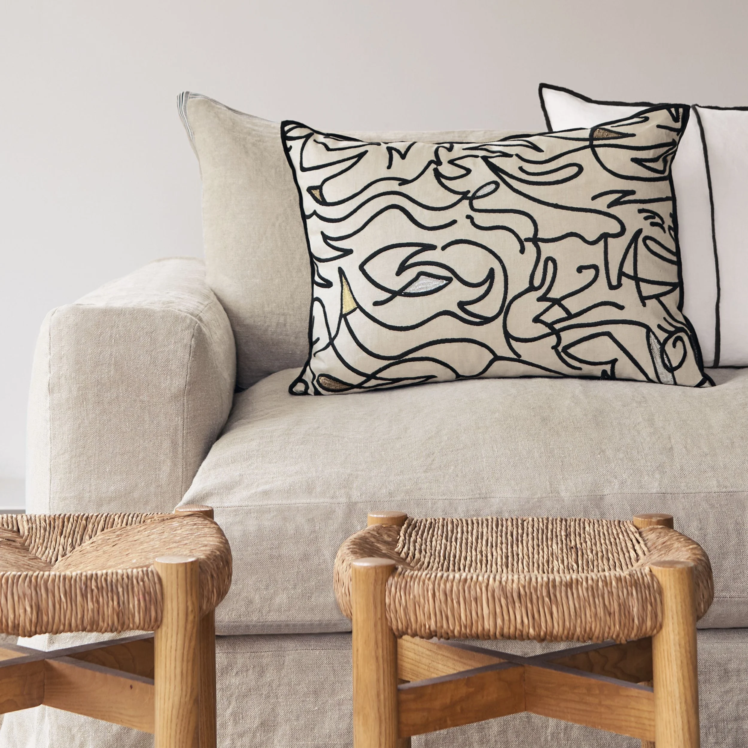 black embroidered rectangular cushion in situ