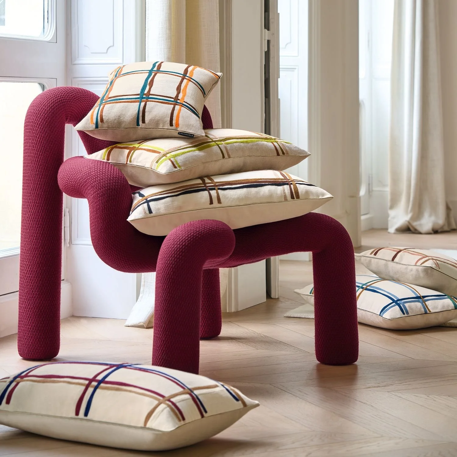 Maison Casamance Oban Bleu Aubergine cushion in a room setting, wider view