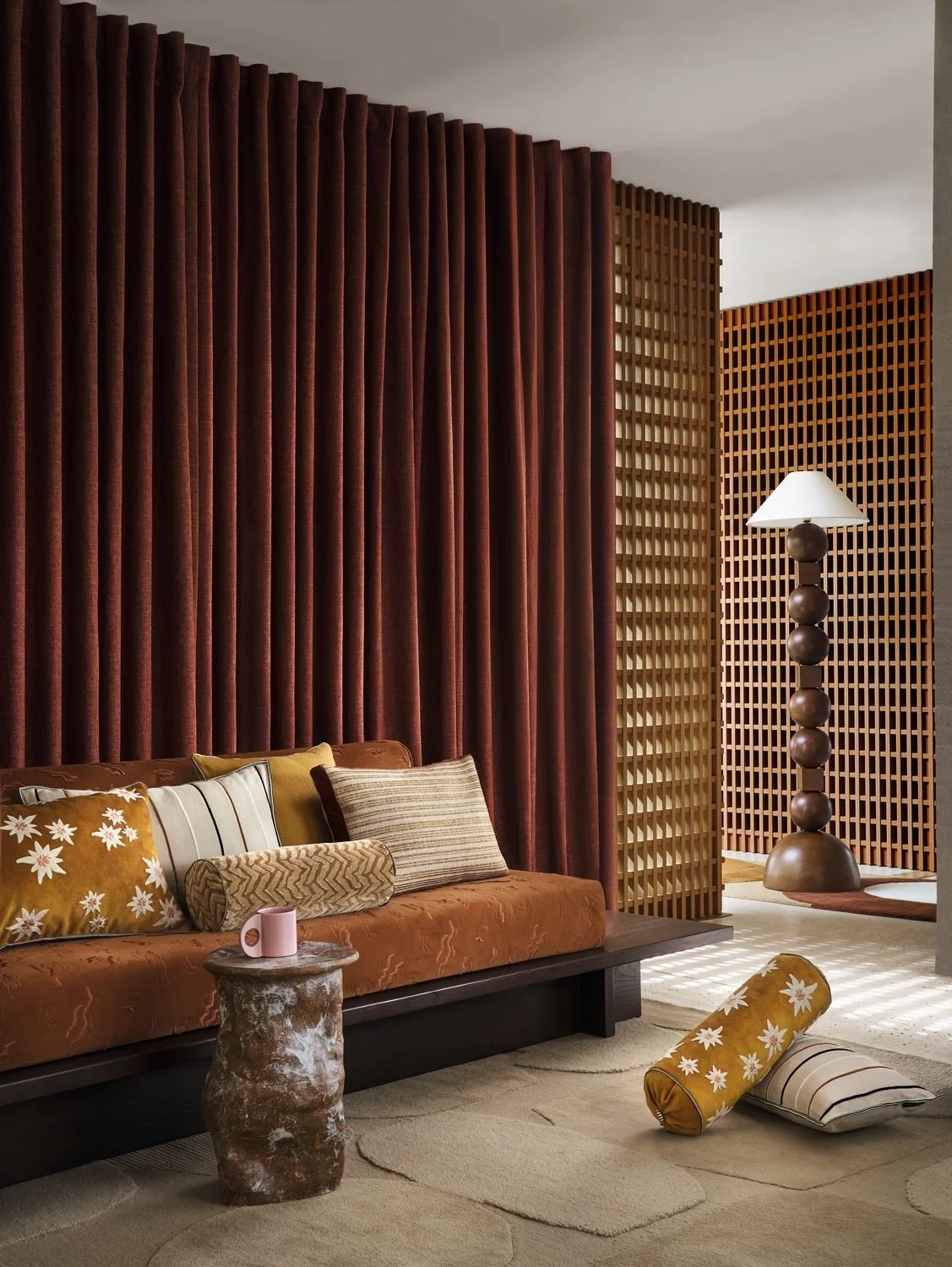 Maison Casamance Ness Jaune Or bolster cushion in a room setting