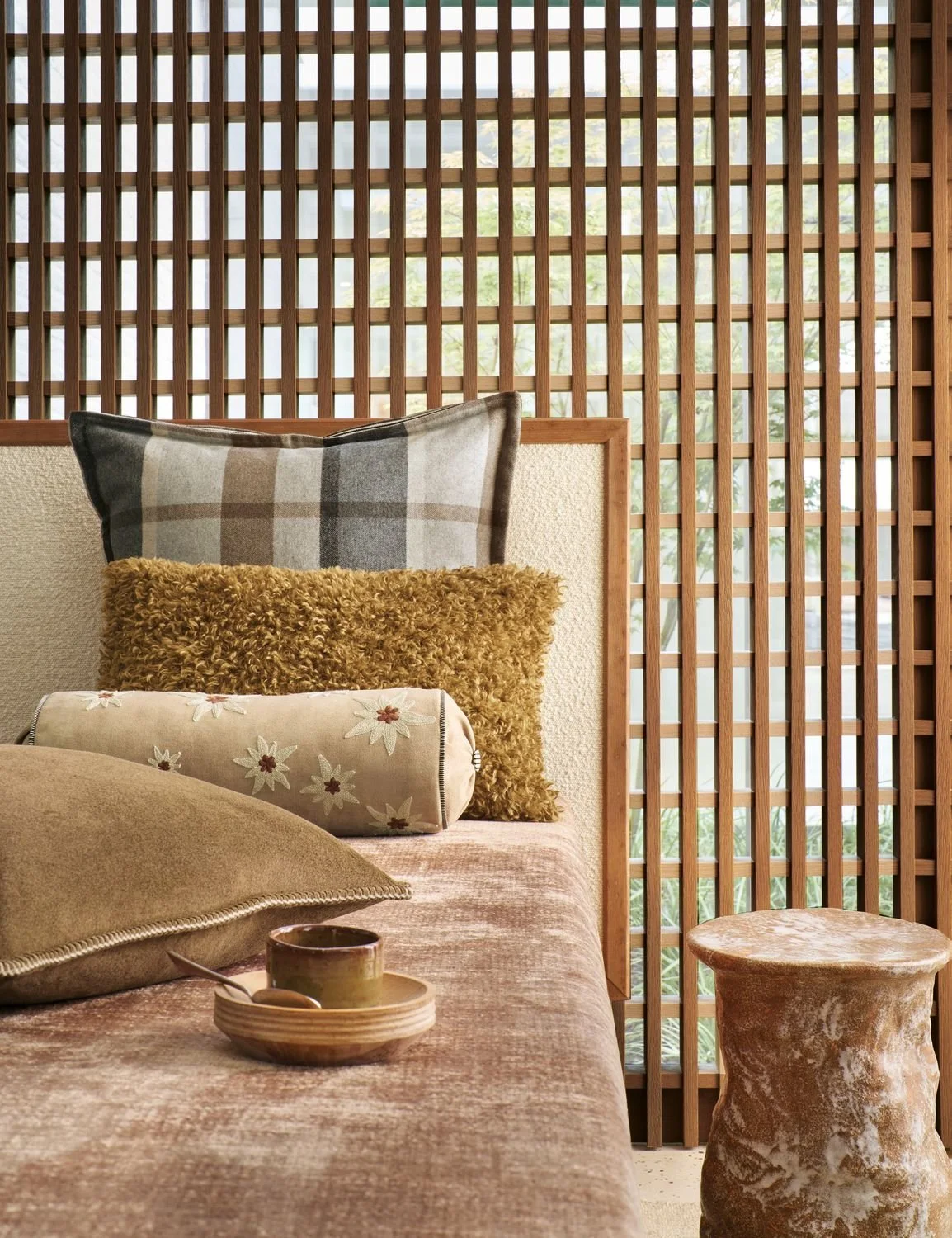 Maison Casamance Ness Noix bolster cushion in a room setting