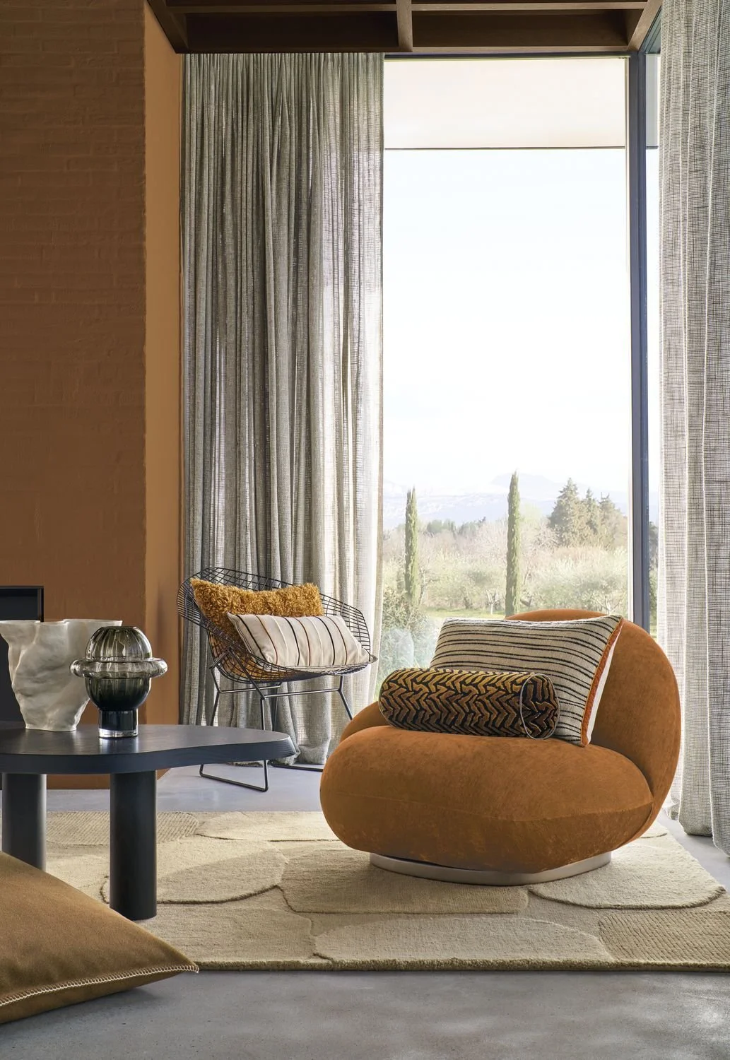 Maison Casamance Silhouette Ocre Noir bolster cushion in a room setting