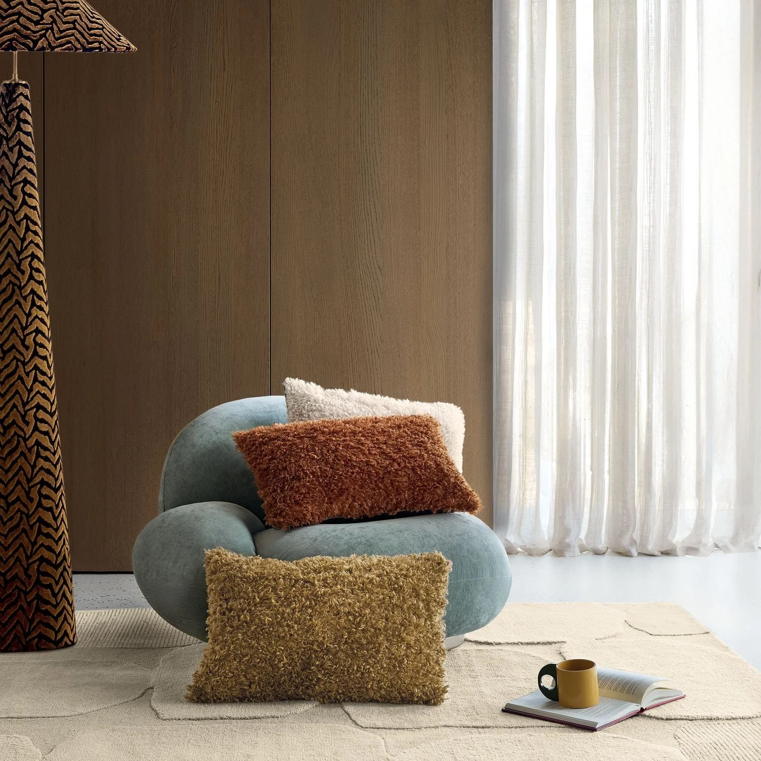 Maison Casamance Sami Orange Brulee cushion in a room setting, wider view