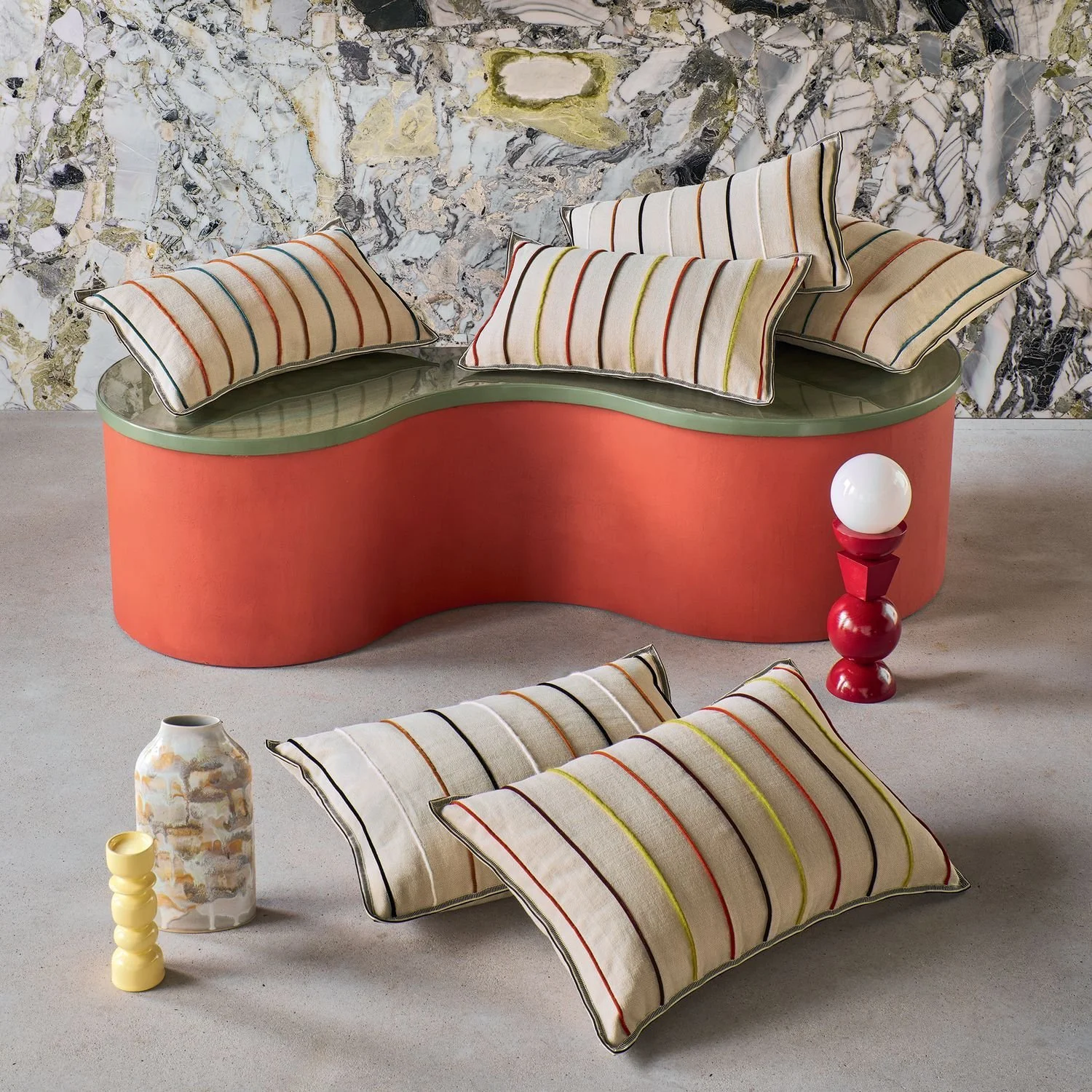 Maison Casamance Killin Orange Bleu cushion in a room setting, wider view