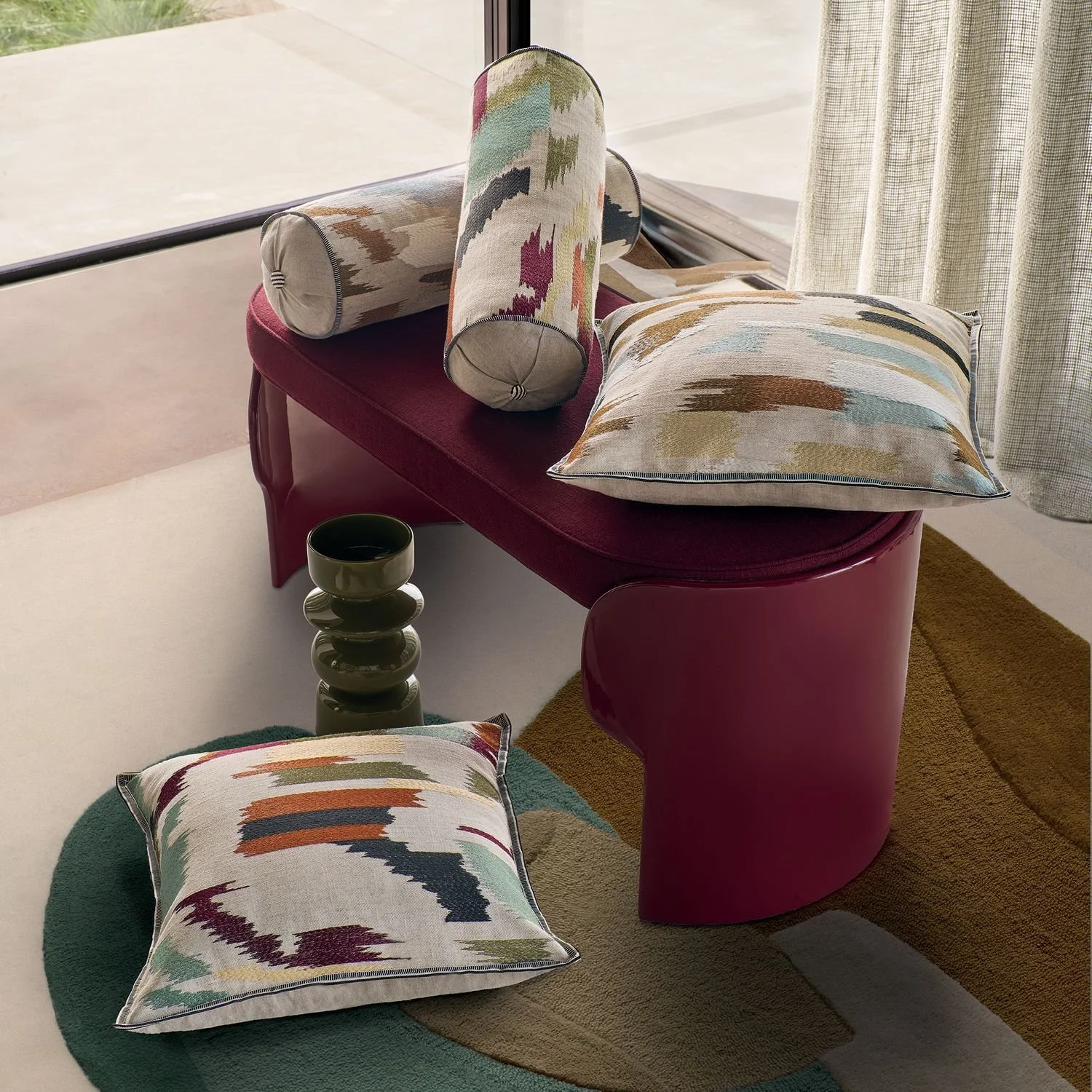 Maison Casamance Benang Multico bolster cushion in a room setting, wider view