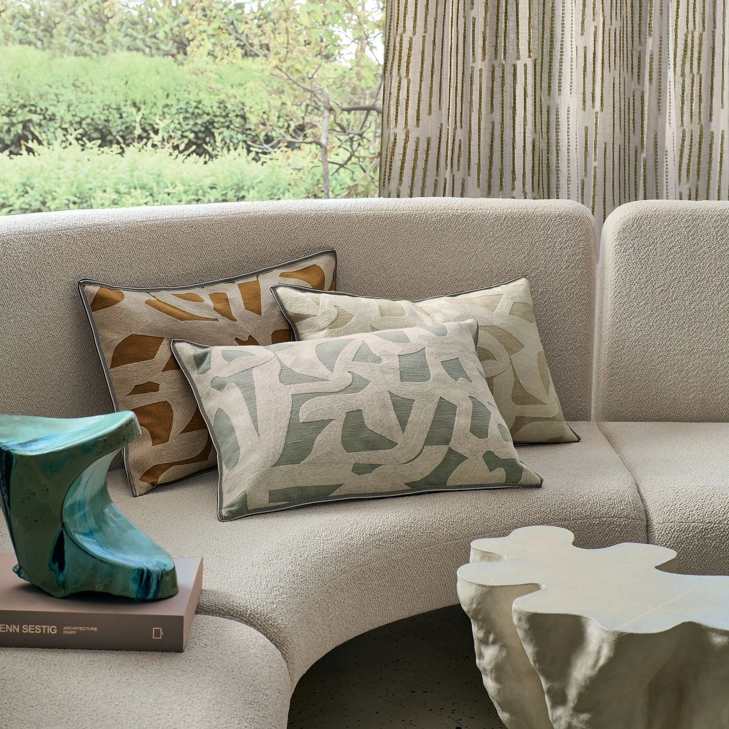 Maison Casamance Mainland Celadon cushion in a room setting, wider view