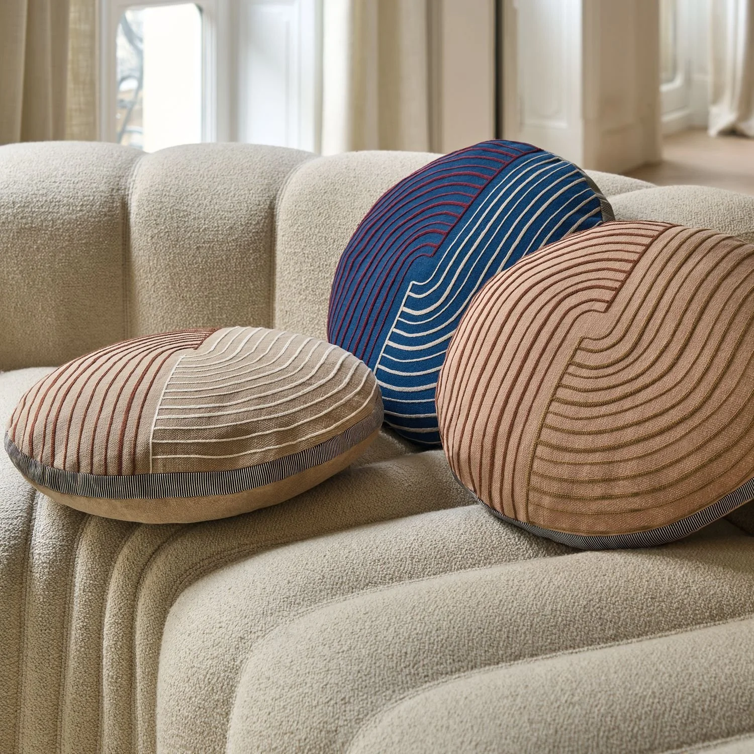 Maison Casamance Mellow Beige round cushion in a room setting, wider view