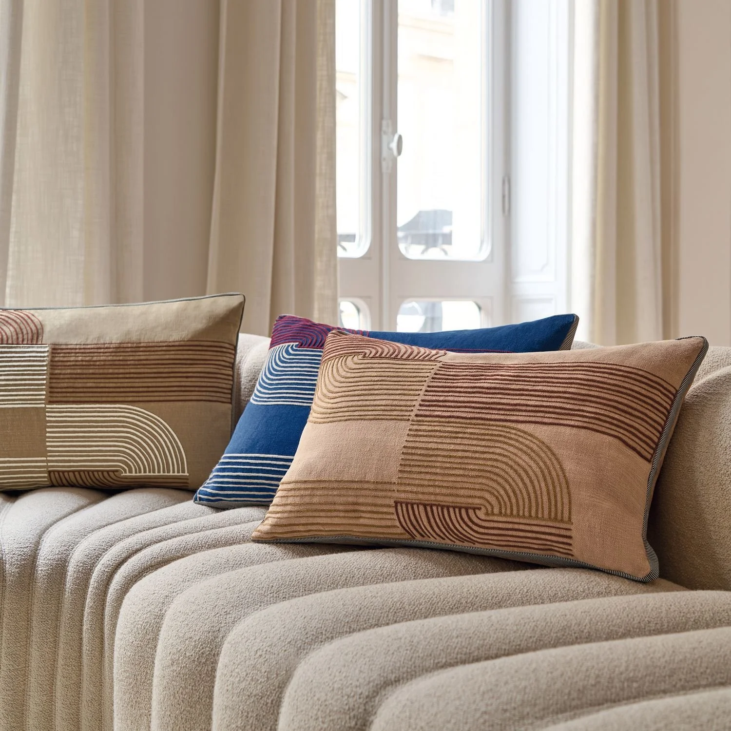 Maison Casamance Mellow Beige cushion in a room setting, wider view
