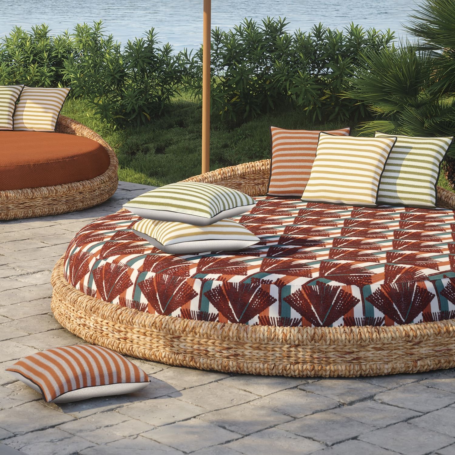 Maison Casamance Levadas Turquoise outdoor cushion in a room setting, wider view