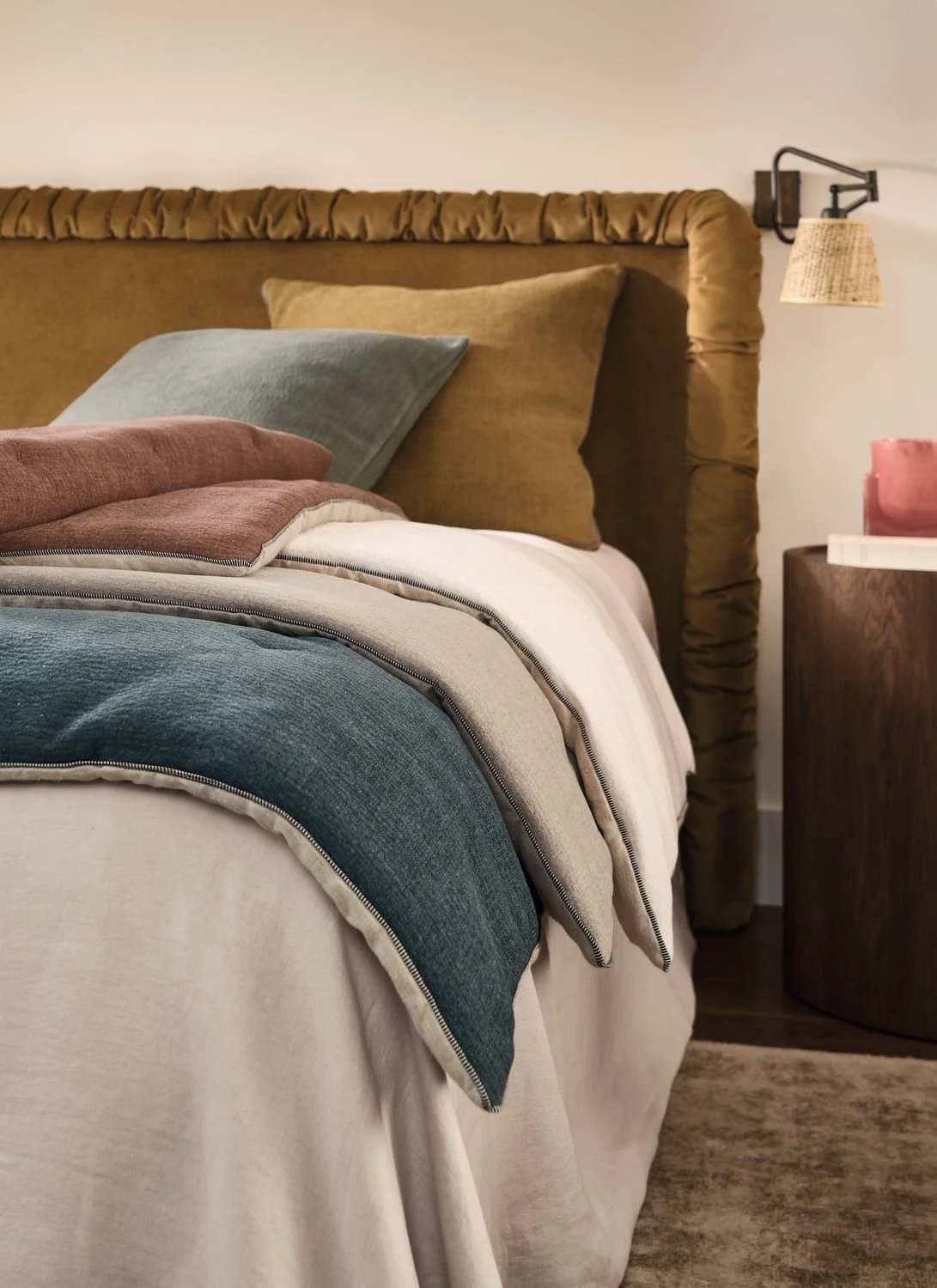 Maison Casamance Rodeo sofa covers and cushions on a bed (shared photo, Rodeo Sofa Cover Vert de Gris)