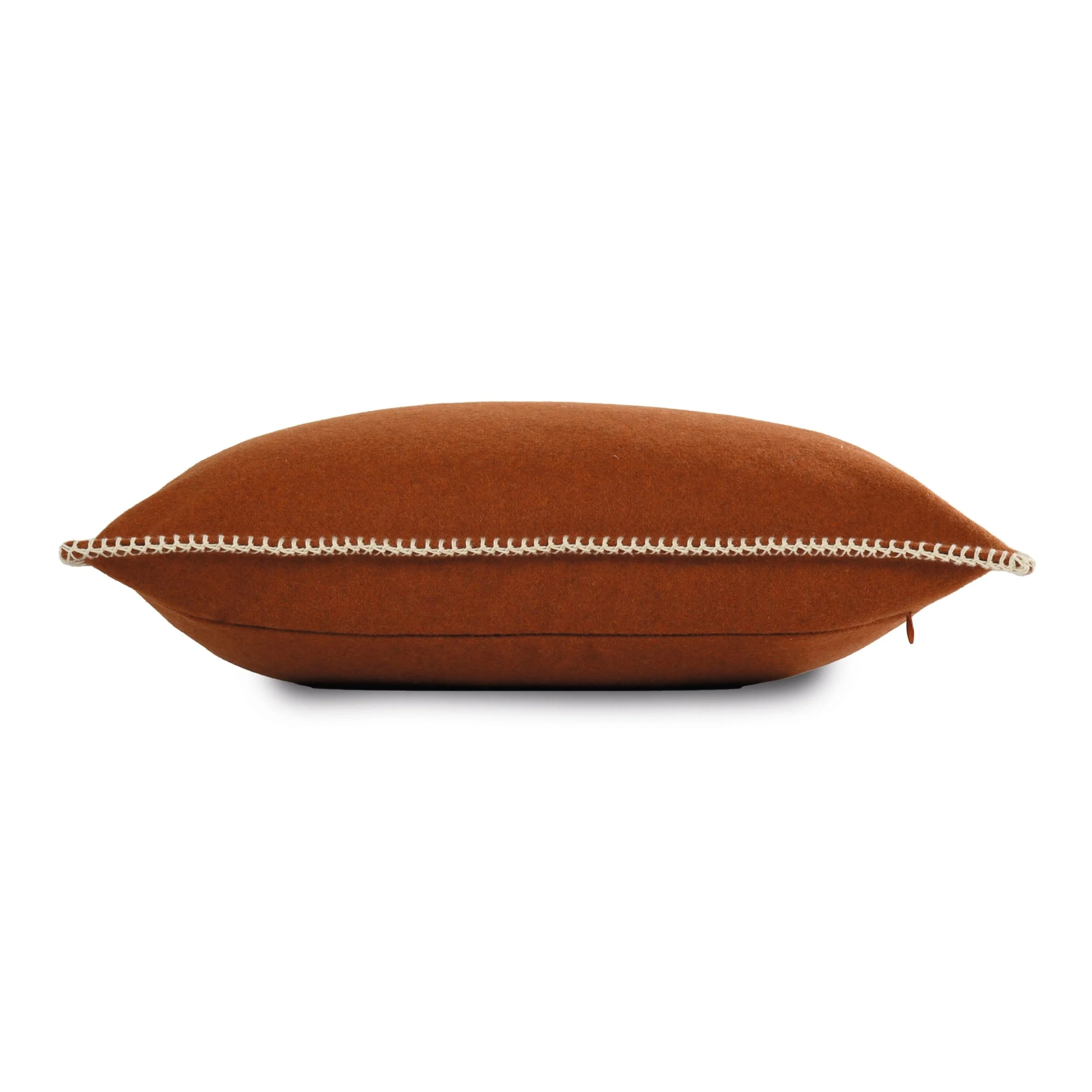 Side view of the Maison Casamance Arthur's Seat Terre de sienne cushion showing the blanket stitch edge