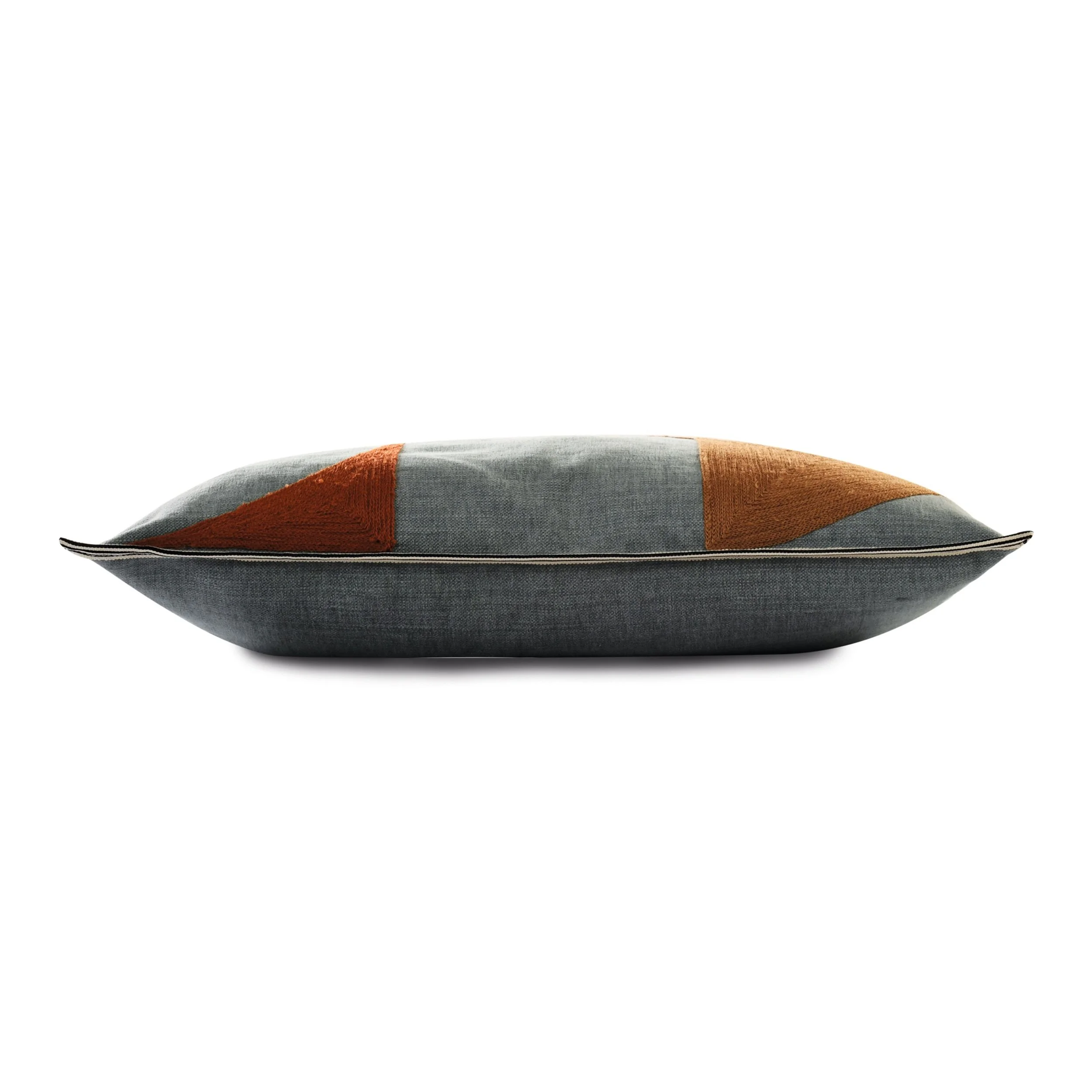 Side view of a Maison Casamance Coconut cushion showing the braid edge and plain linen cotton reverse