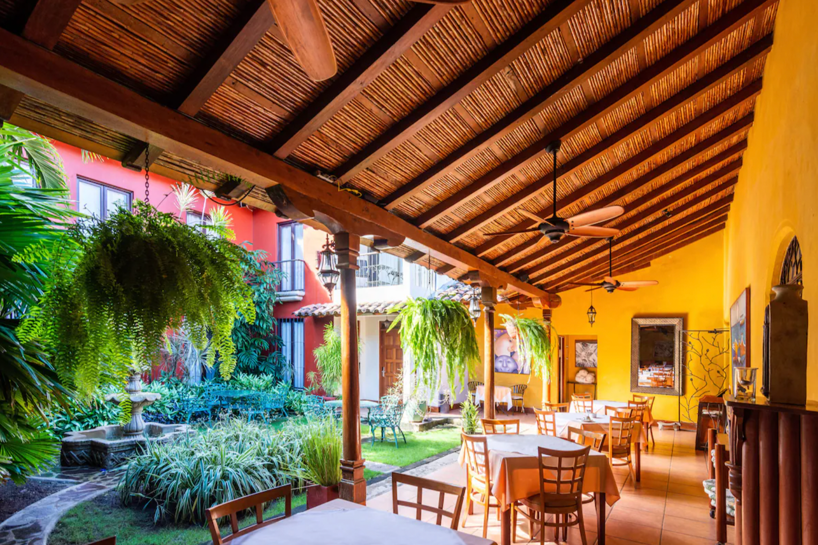 The outdoor dining area next to a lush courtyard at Estrada Hotel & Bistro, one of the top places to visit in Nicaragua