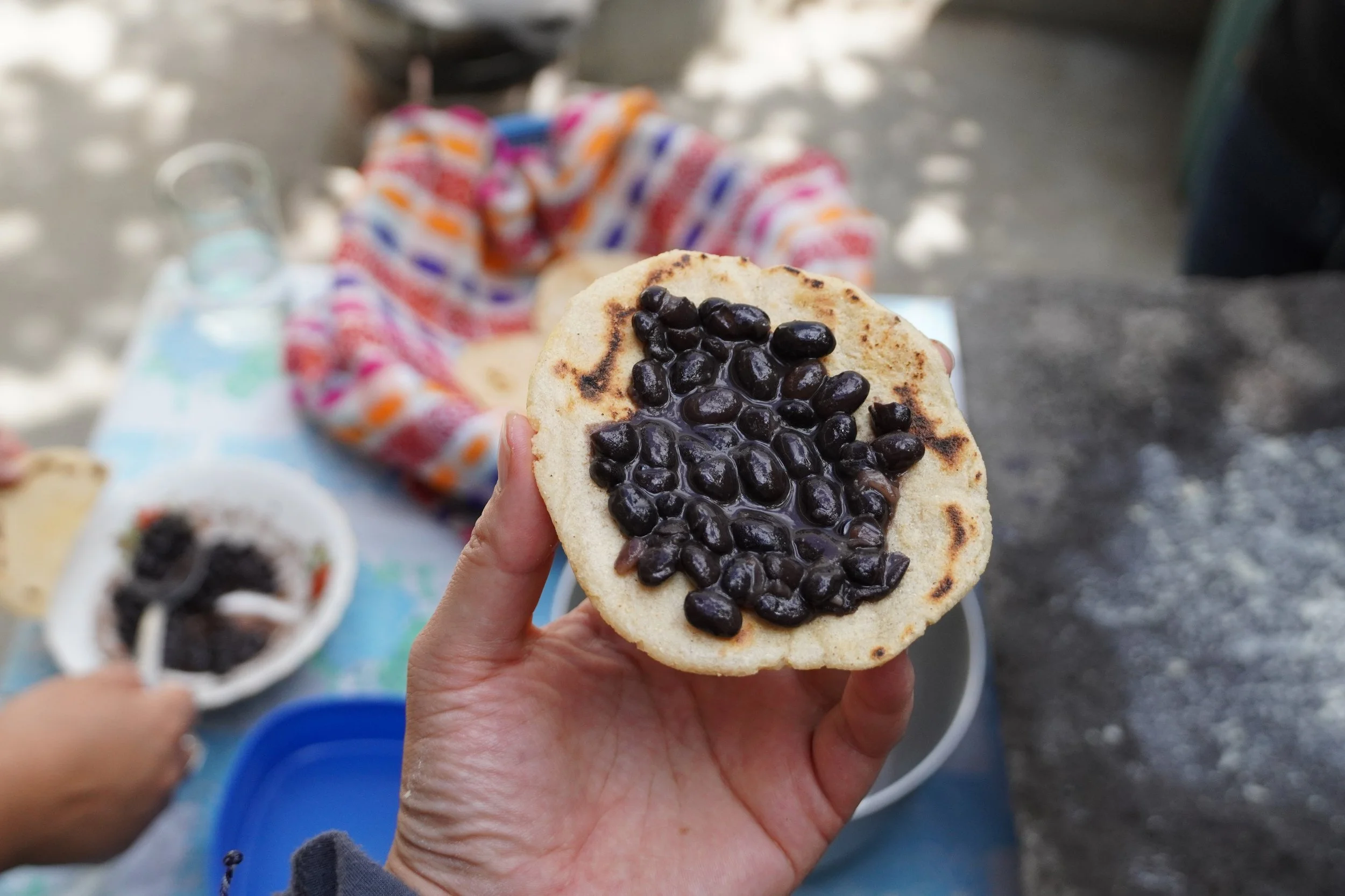 Black beans are in a handmade tortilla, a perfect example of vegan food in Guatemala